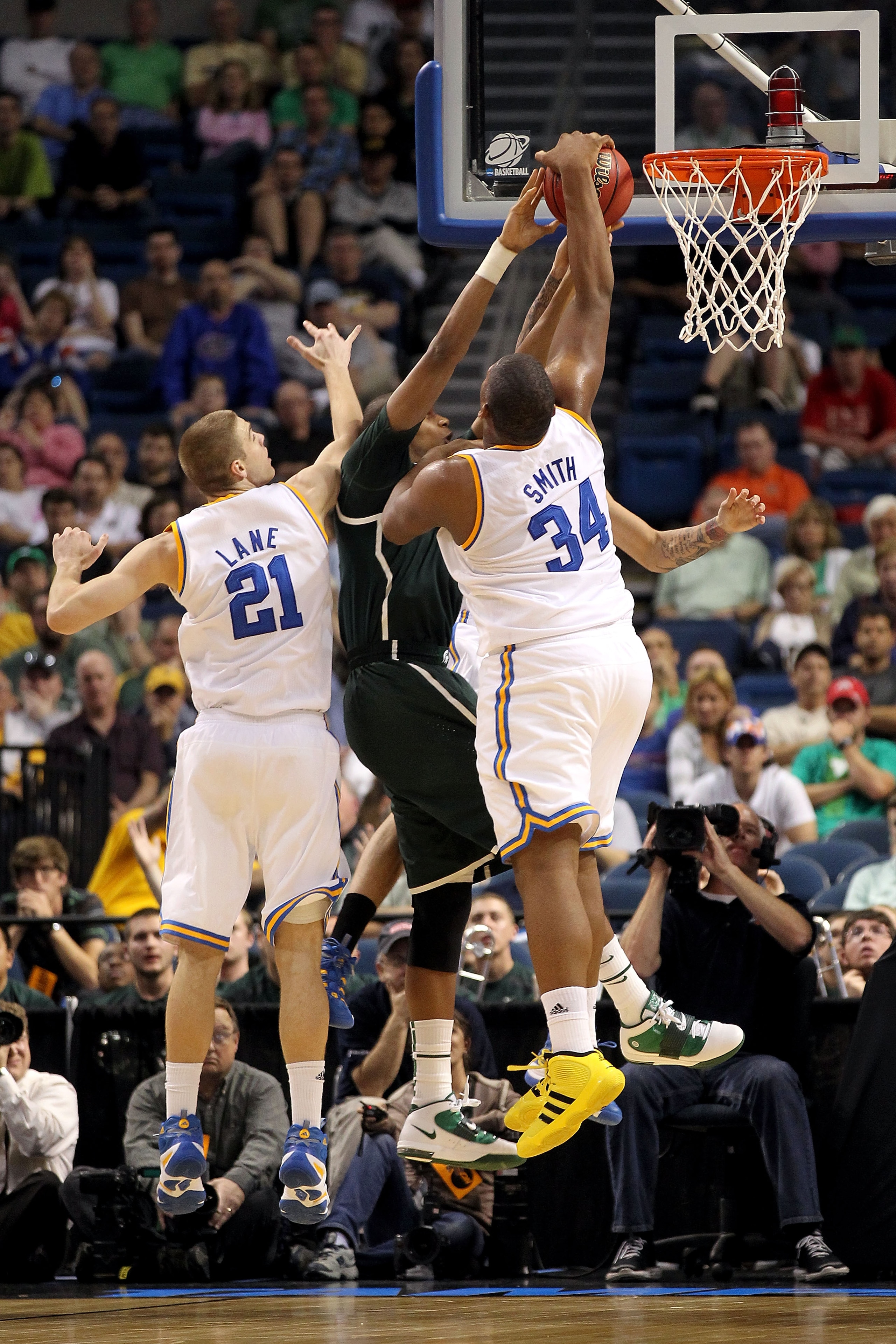 TAMPA, FL - MARCH 17: Joshua Smith #34 of the UCLA Bruins blocks a shot attempt by Adreian Payne #5 of the Michigan State Spartans  during the second round of the 2011 NCAA men's basketball tournament at St. Pete Times Forum on March 17, 2011 in Tampa, Fl