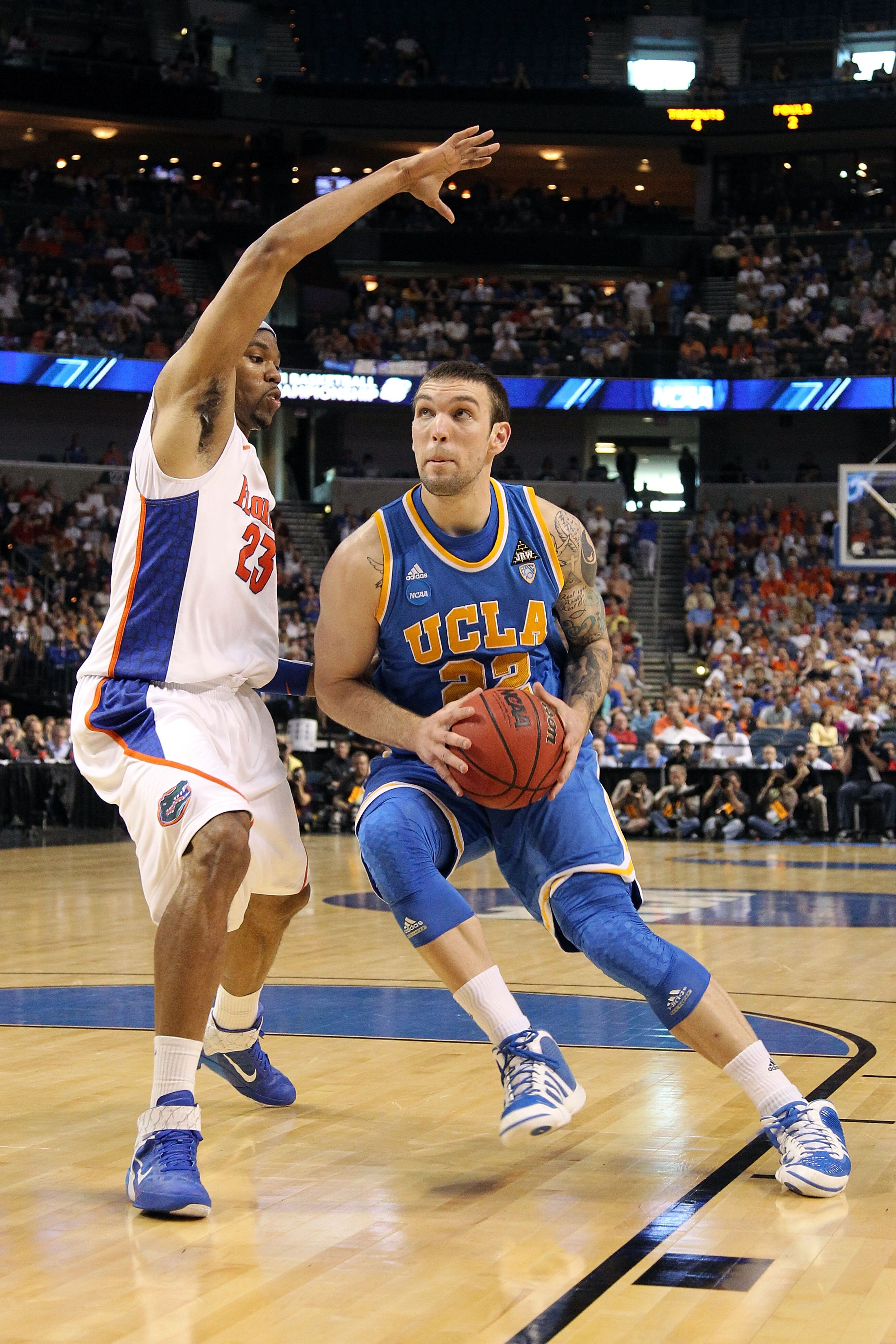 TAMPA, FL - MARCH 19:  Reeves Nelson #22 of the UCLA Bruins drives against Alex Tyus #23 of the Florida Gators during the third round of the 2011 NCAA men's basketball tournament at St. Pete Times Forum on March 19, 2011 in Tampa, Florida.  (Photo by Mike
