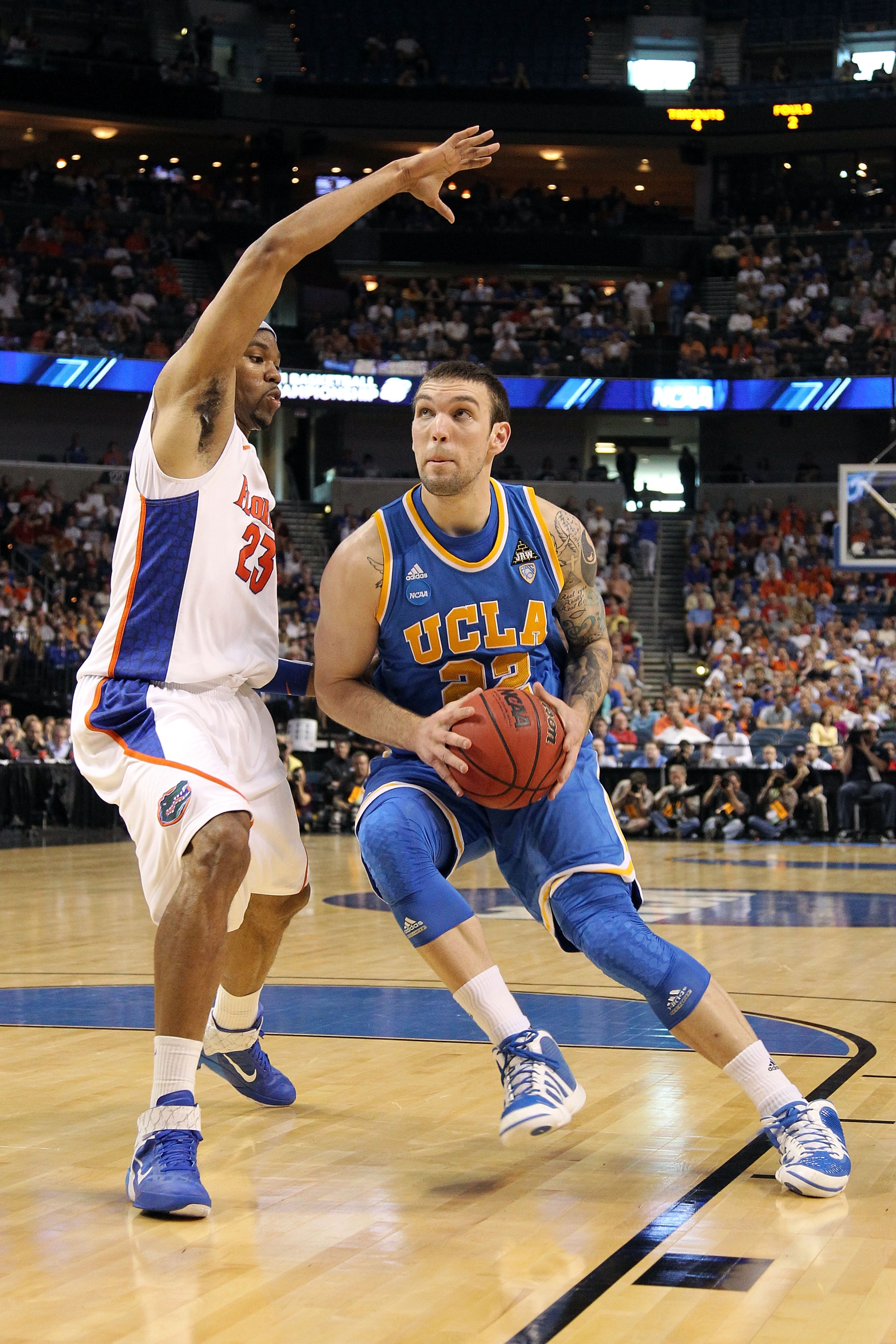 TAMPA, FL - MARCH 19:  Reeves Nelson #22 of the UCLA Bruins drives against Alex Tyus #23 of the Florida Gators during the third round of the 2011 NCAA men's basketball tournament at St. Pete Times Forum on March 19, 2011 in Tampa, Florida.  (Photo by Mike