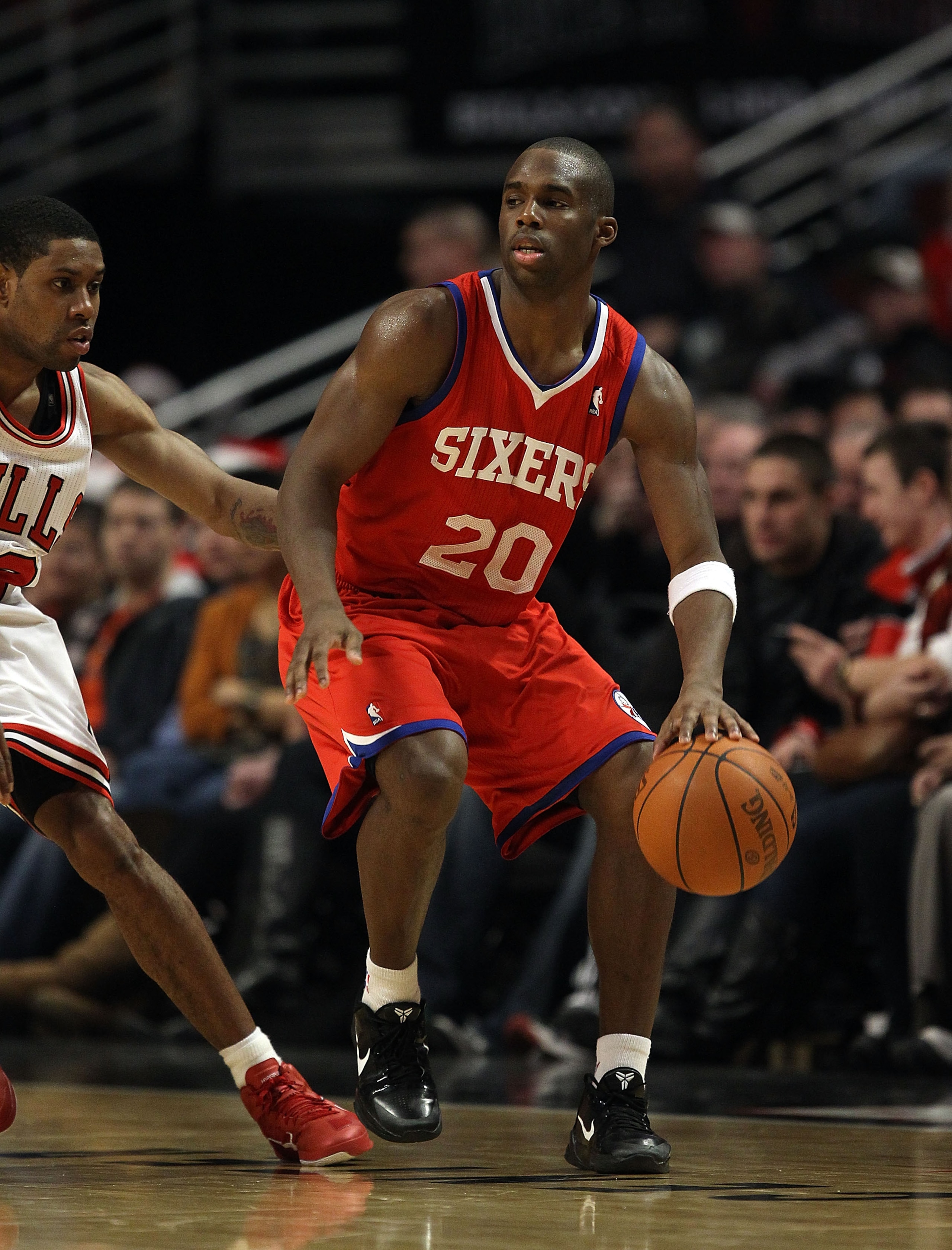 CHICAGO, IL - DECEMBER 21: Jodie Meeks #20 of the Philadelphia 76ers moves against C.J. Watson #32 of the Chicago Bulls at the United Center on December 21, 2010 in Chicago, Illinois. The Bulls defeated the 76ers 121-76. NOTE TO USER: User expressly ackno
