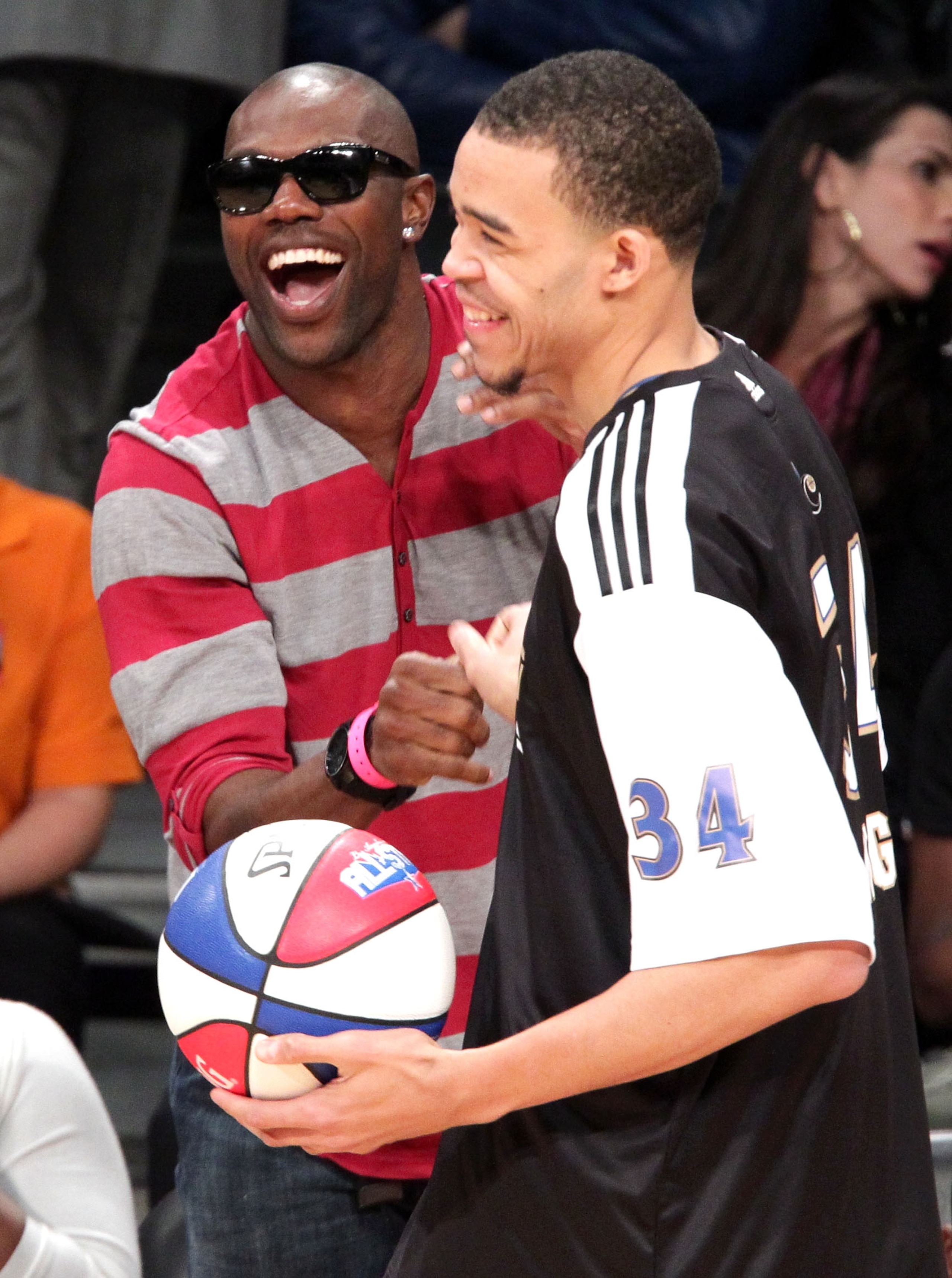 LOS ANGELES, CA - FEBRUARY 19:  NFL player Terrell Owens (L) shakes hands with NBA player for the Washington Wizards JaVale McGee during NBA All-Star Saturday night presented by State Farm at Staples Center on February 19, 2011 in Los Angeles, California.