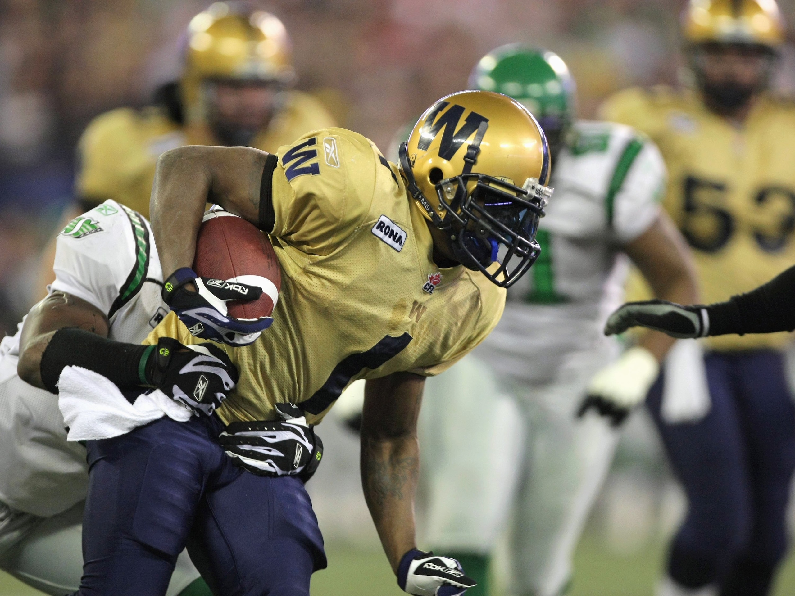 TORONTO - NOVEMBER 25:  Charles Roberts #1 of the Winnipeg Blue Bombers tries to break a tackle against the Saskatchewan Rough Riders during the first quarter of the 95th Grey Cup on November 25, 2007 at the Rogers Centre in Toronto, Ontario, Canada.  The