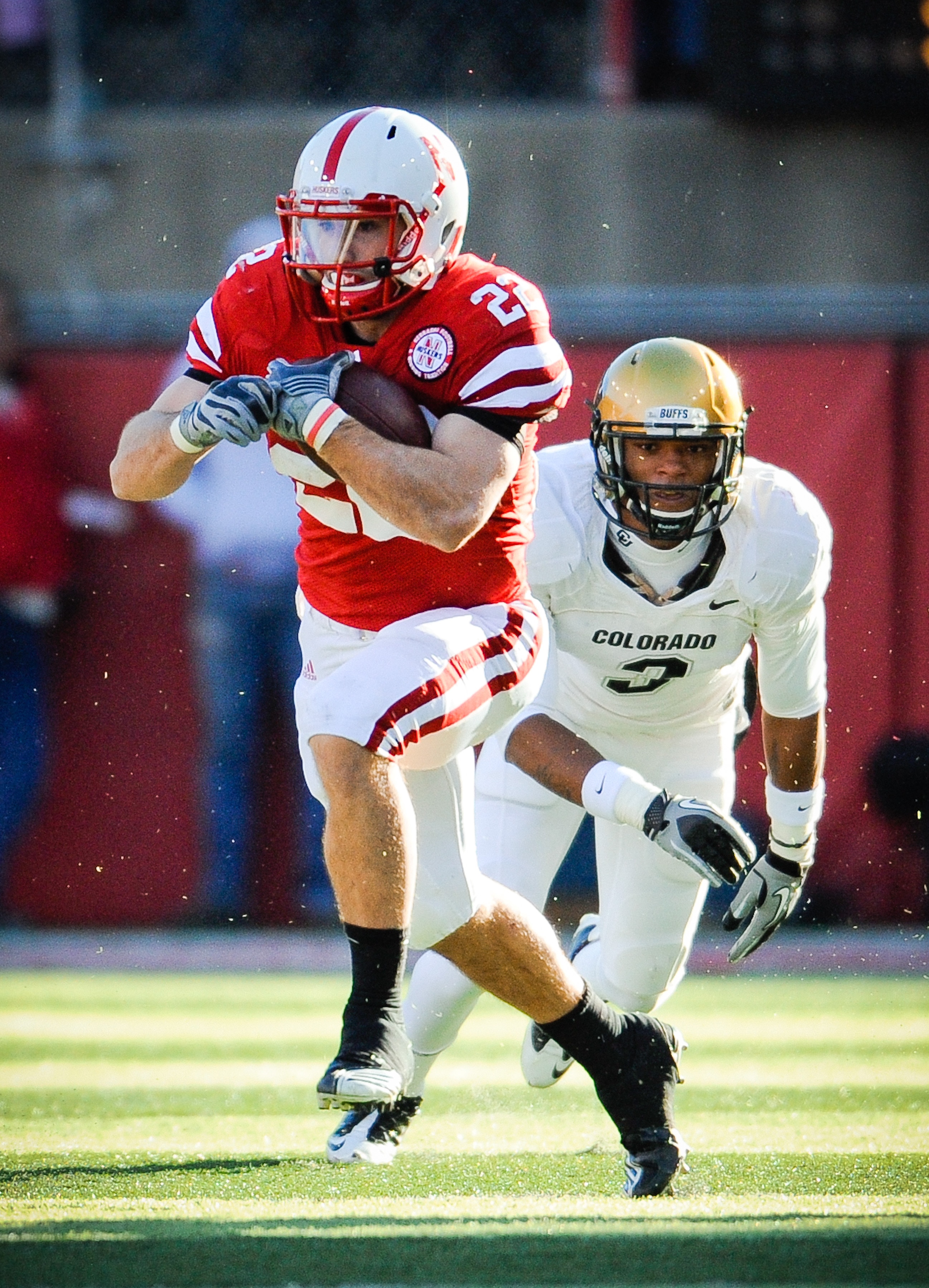 LINCOLN, NE - NOVEMBER 26: Rex Burkhead #22 of the Nebraska Cornhuskers slips past Jimmy Smith #3 of the Colorado Buffaloes during their game at Memorial Stadium on November 26, 2010 in Lincoln, Nebraska. Nebraska defeated Colorado 45-17 (Photo by Eric Fr