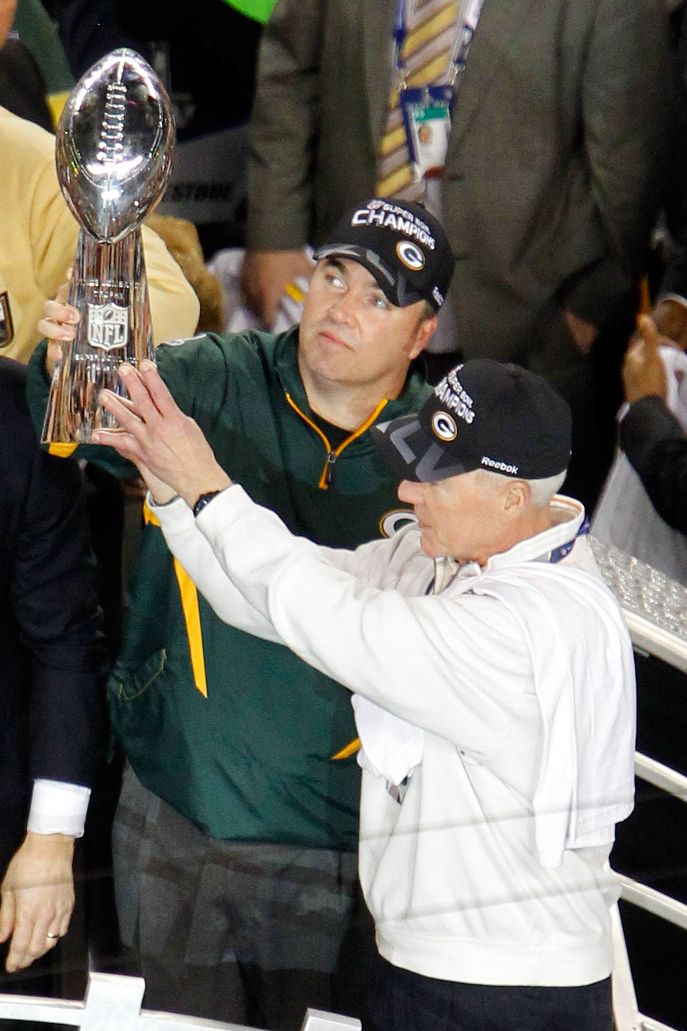 ARLINGTON, TX - FEBRUARY 06:  Head coach Mike McCarthy of the Green Bay Packers holds up The Vince Lombardi Trophy with General manager Ted Thompson after the Green Bay Packers defeated the Pittsburgh Steelers 31 to 25 in Super Bowl XLV at Cowboys Stadium