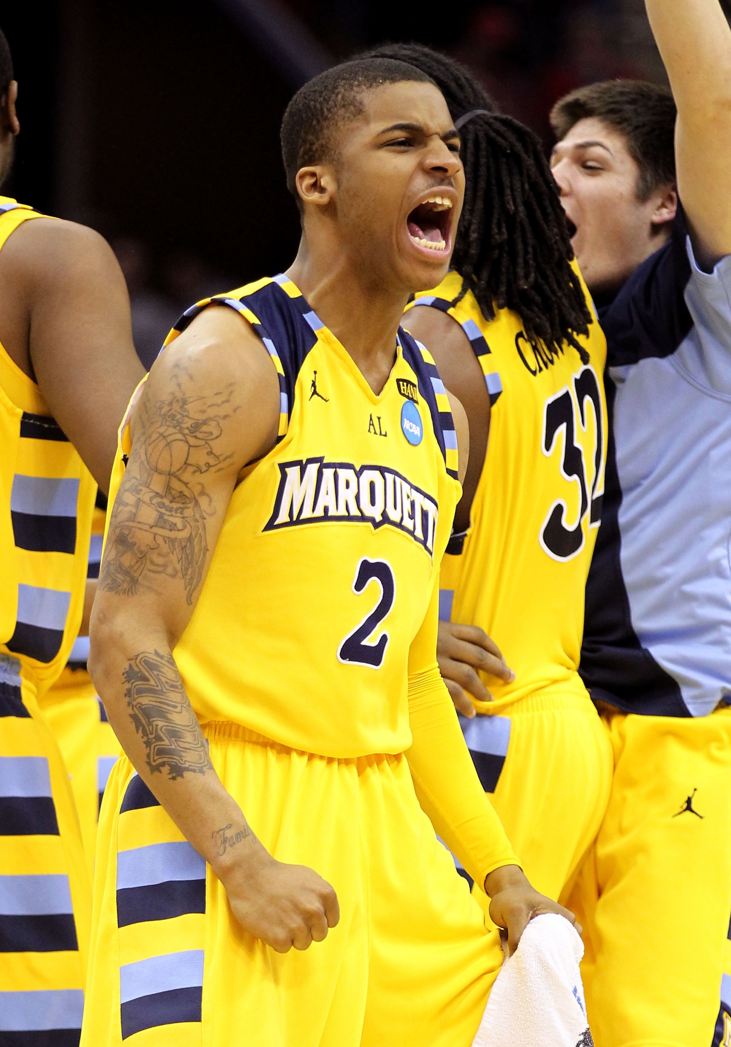 CLEVELAND, OH - MARCH 20: Vander Blue #2 of the Marquette Golden Eagles celebrates with teammates after defeating the Syracuse Orange during the third of the 2011 NCAA men's basketball tournament at Quicken Loans Arena on March 20, 2011 in Cleveland, Ohio