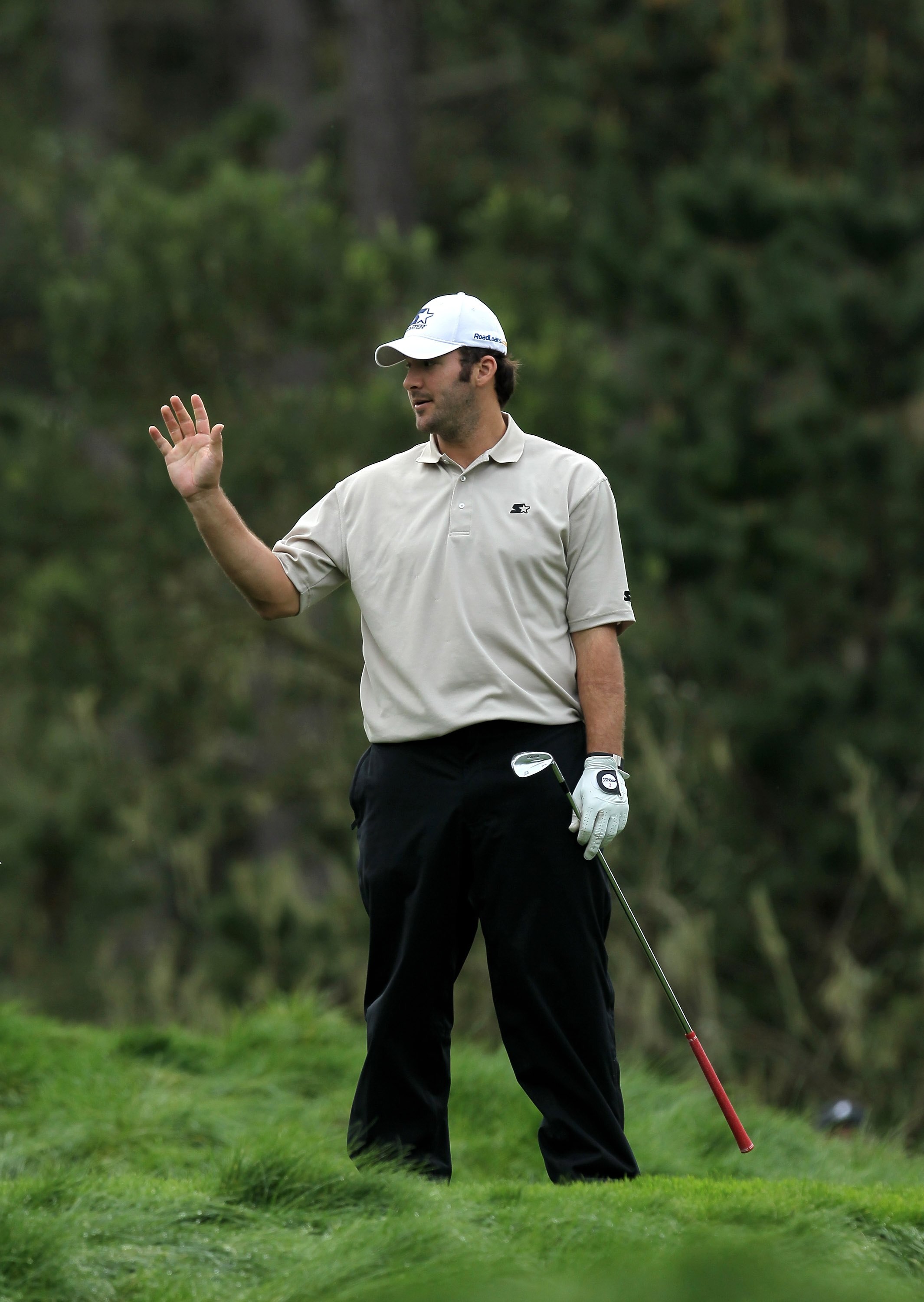 PEBBLE BEACH, CA - FEBRUARY 12:  Dallas Cowboys quarterback Tony Romo waves after hitting his tee shot on the 12th hole during the second round of the AT&T Pebble Beach National Pro-Am at Spyglass Hill Golf Course on February 12 2010 in Pebble Beach, Cali