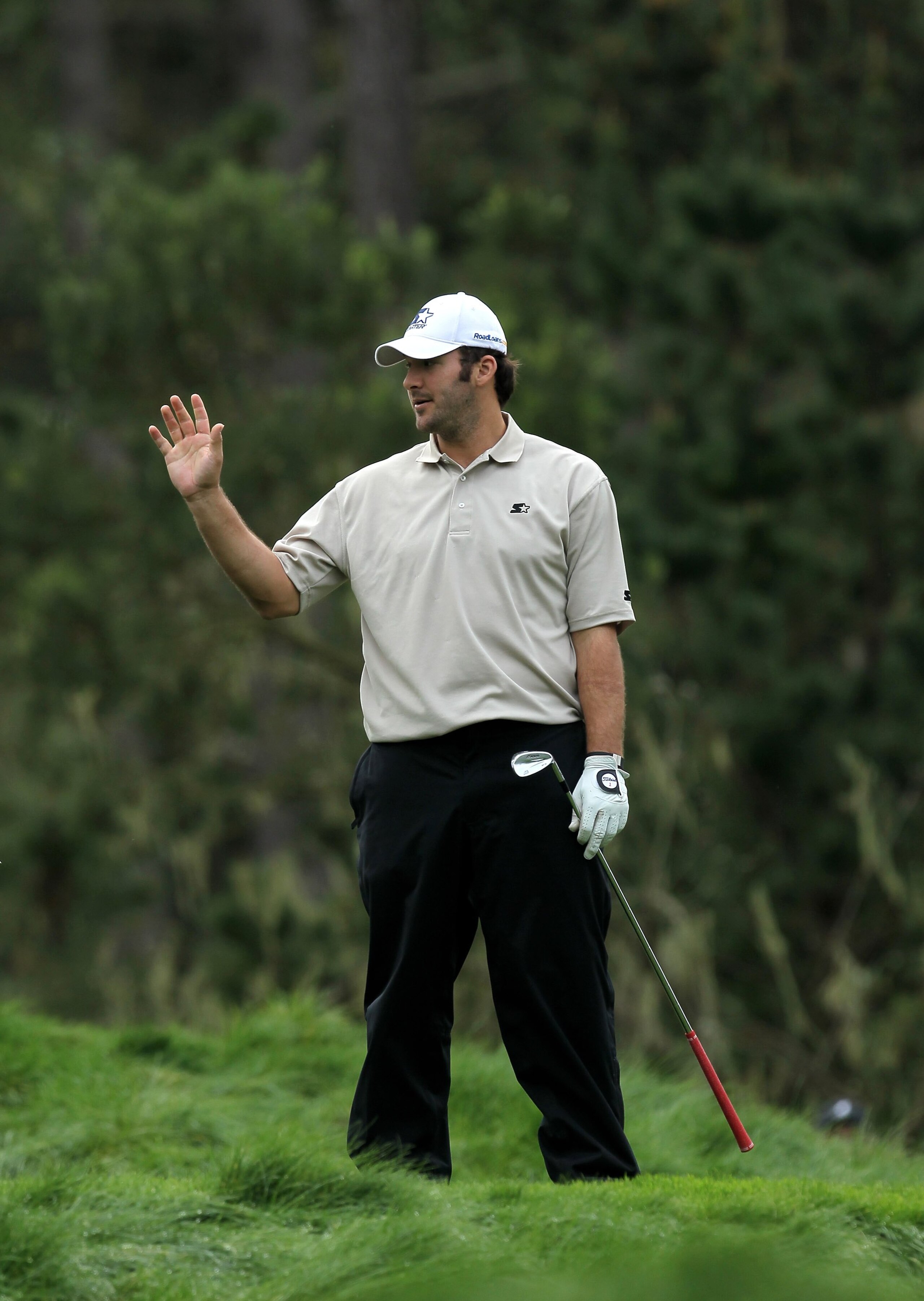 PEBBLE BEACH, CA - FEBRUARY 12:  Dallas Cowboys quarterback Tony Romo waves after hitting his tee shot on the 12th hole during the second round of the AT&T Pebble Beach National Pro-Am at Spyglass Hill Golf Course on February 12 2010 in Pebble Beach, Cali