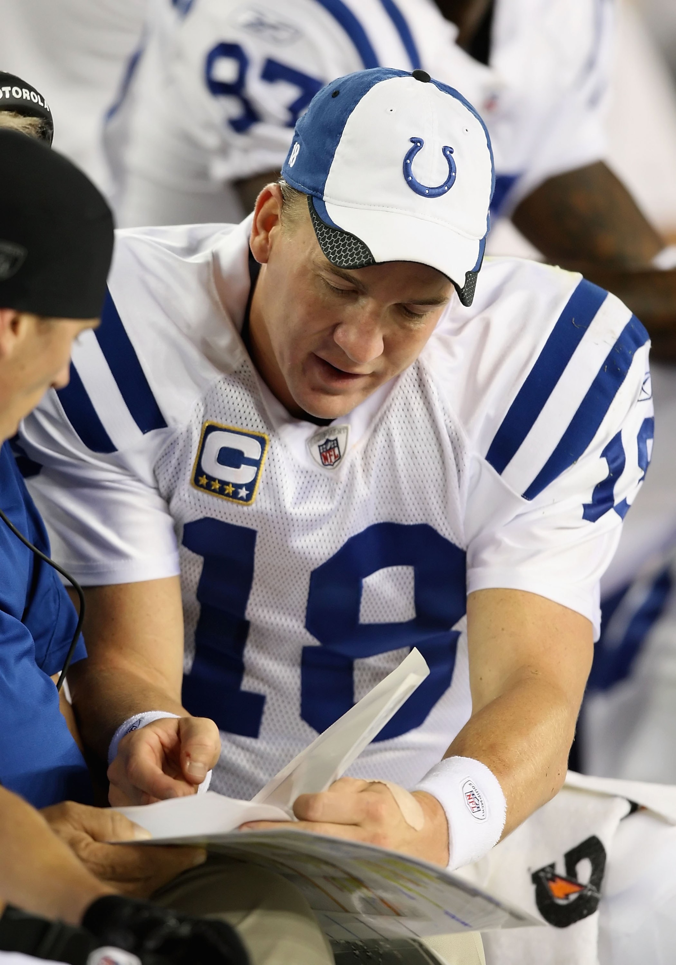 GLENDALE, AZ - SEPTEMBER 27:  Quarterback Peyton Manning #18 of the Indianapolis Colts looks at a play book  during the NFL game against the Arizona Cardinals at the Universtity of Phoenix Stadium on September 27, 2009 in Glendale, Arizona.  The Colts def