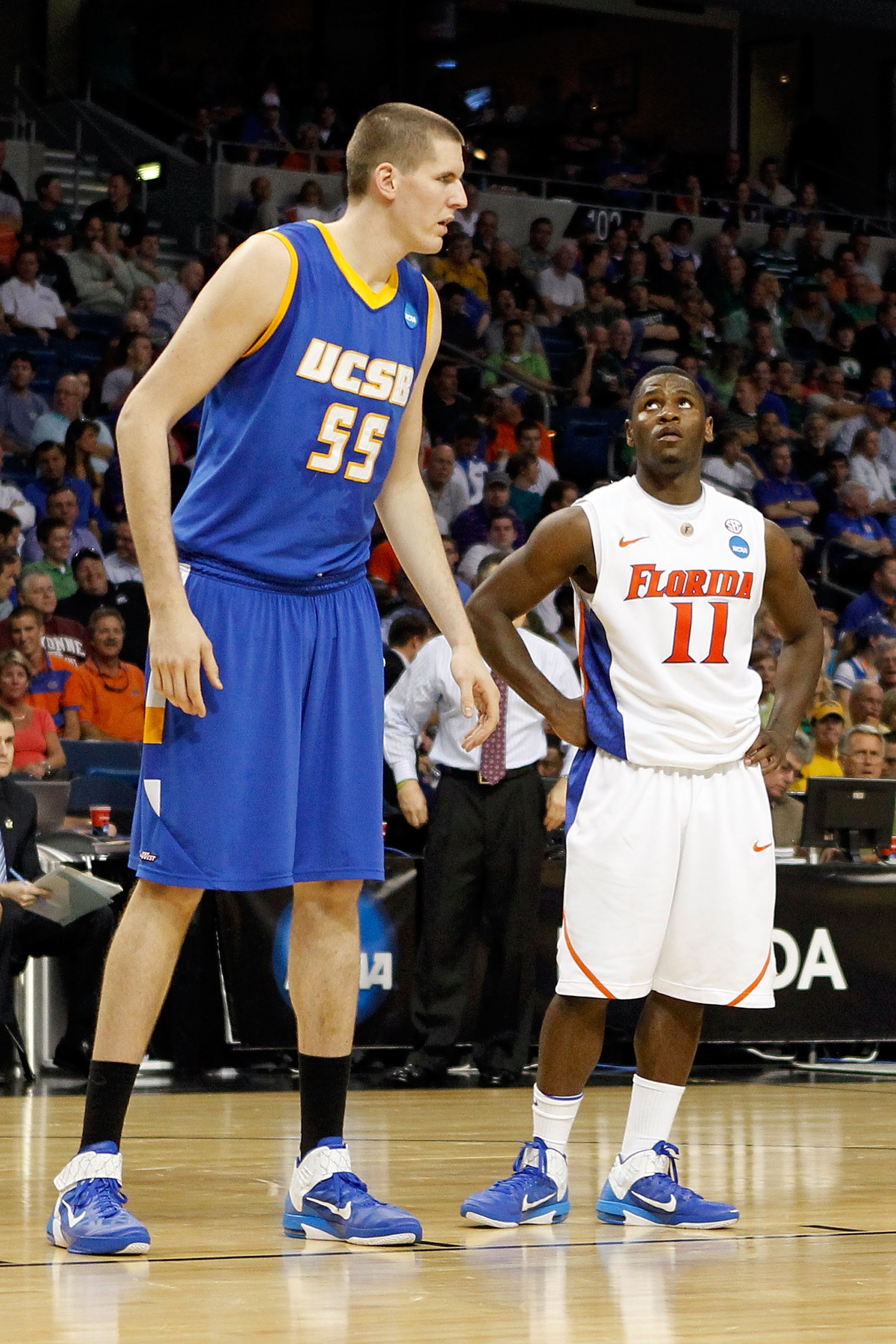 TAMPA, FL - MARCH 17:  Erving Walker #11 of the Florida Gators looks up at Greg Somogyi #55 of the UC Santa Barbara Gauchos during the second round of the 2011 NCAA men's basketball tournament at St. Pete Times Forum on March 17, 2011 in Tampa, Florida. F