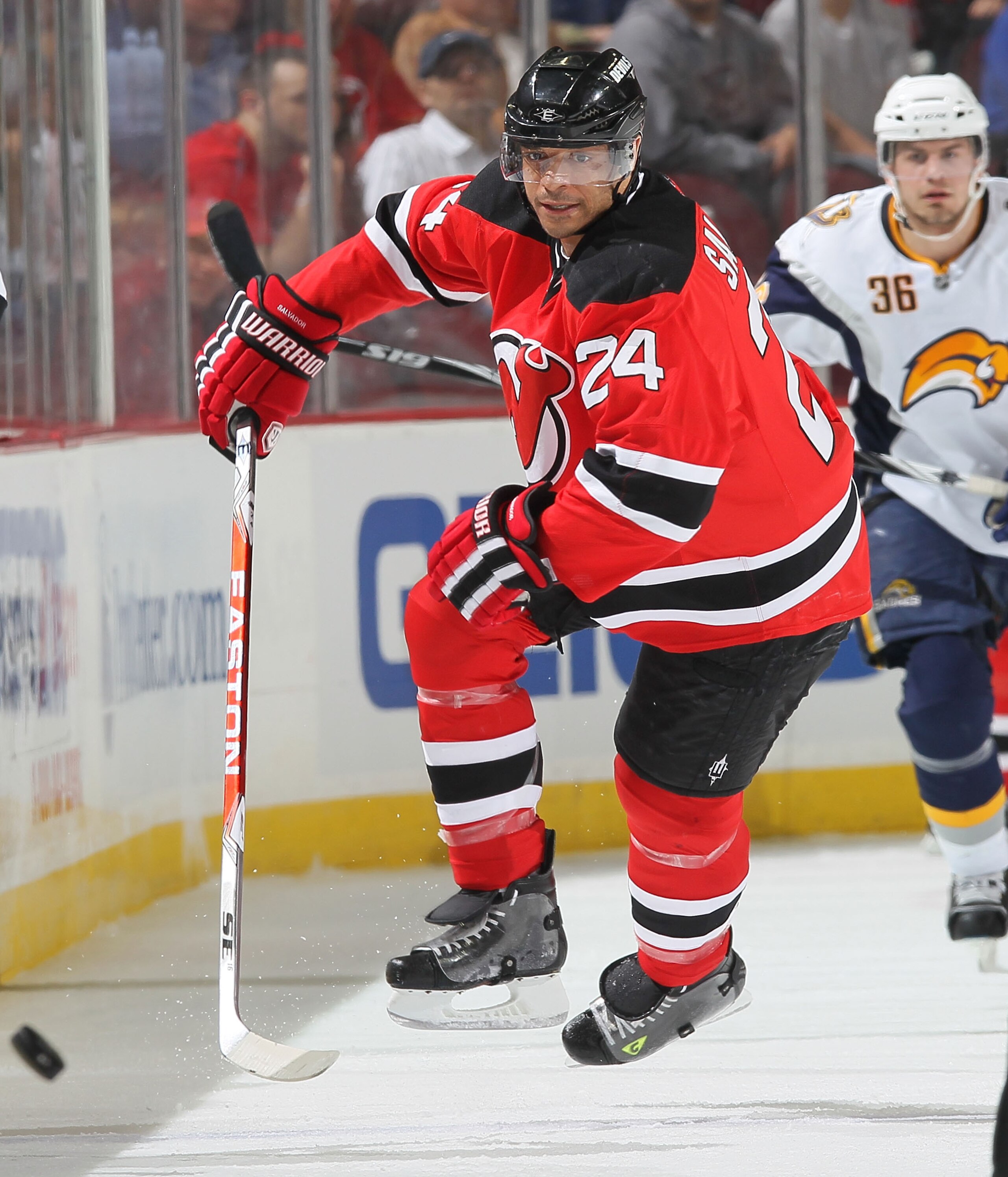 NEWARK, NJ - APRIL 11: Bryce Salvador #24 of the New Jersey Devils chases the puck against the Buffalo Sabres at the Prudential Center on April 11, 2010 in Newark, New Jersey.  (Photo by Chris McGrath/Getty Images)