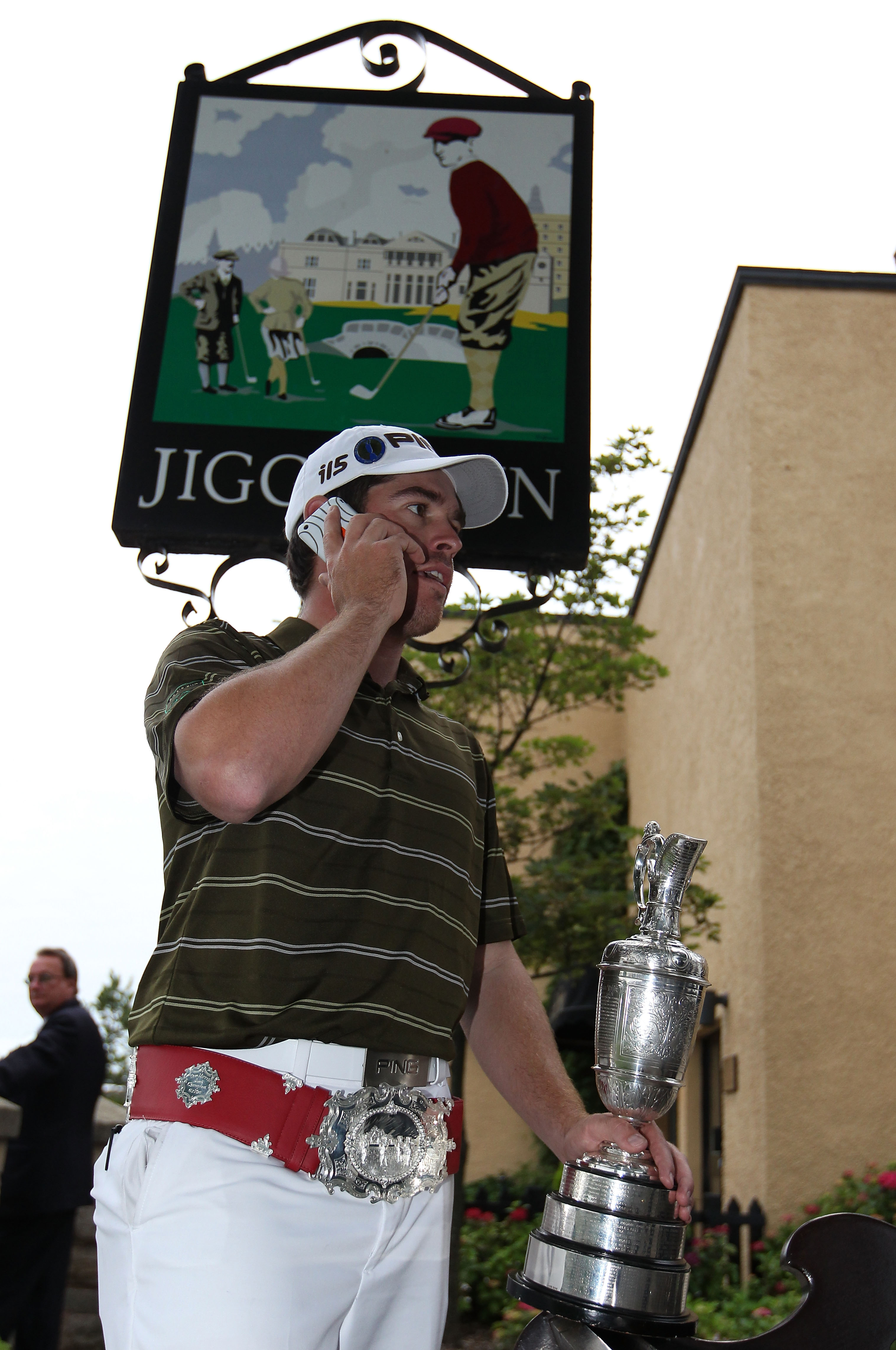 ST ANDREWS, SCOTLAND - JULY 18:  Louis Oosthuizen of South Africa chats on a mobile phone outside the Jigger Inn on the Old Course, St Andrews on July 18, 2010 in St Andrews, Scotland.  (Photo by Ross Kinnaird/Getty Images)