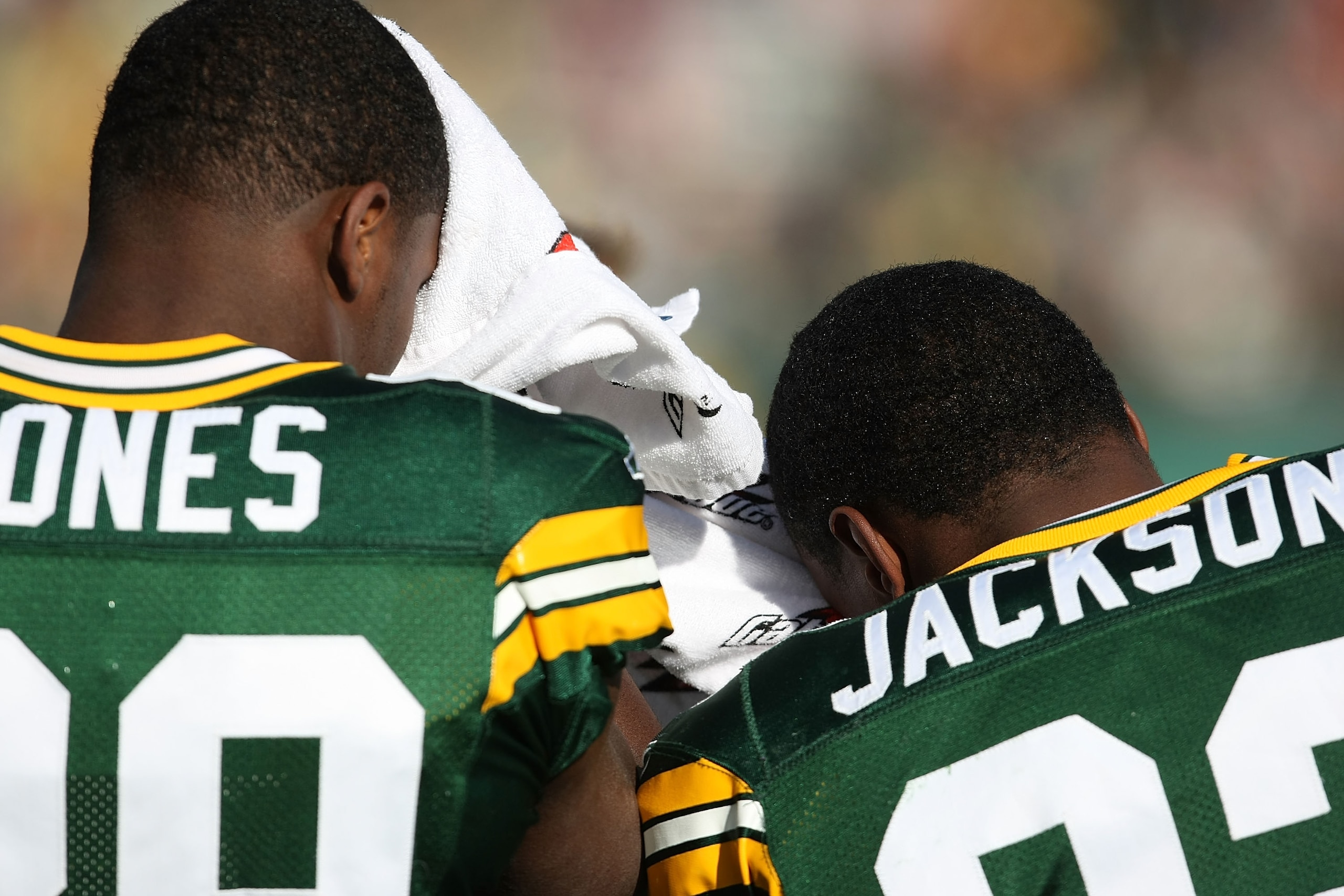 GREEN BAY, WI - NOVEMBER 18: James Jones #89 (L) and Brandon Jackson #32 of the Green Bay Packers share a towel to wipe off after warm-ups before a game against the Carolina Panthers on November 18, 2007 at Lambeau Field in Green Bay, Wisconsin. (Photo by