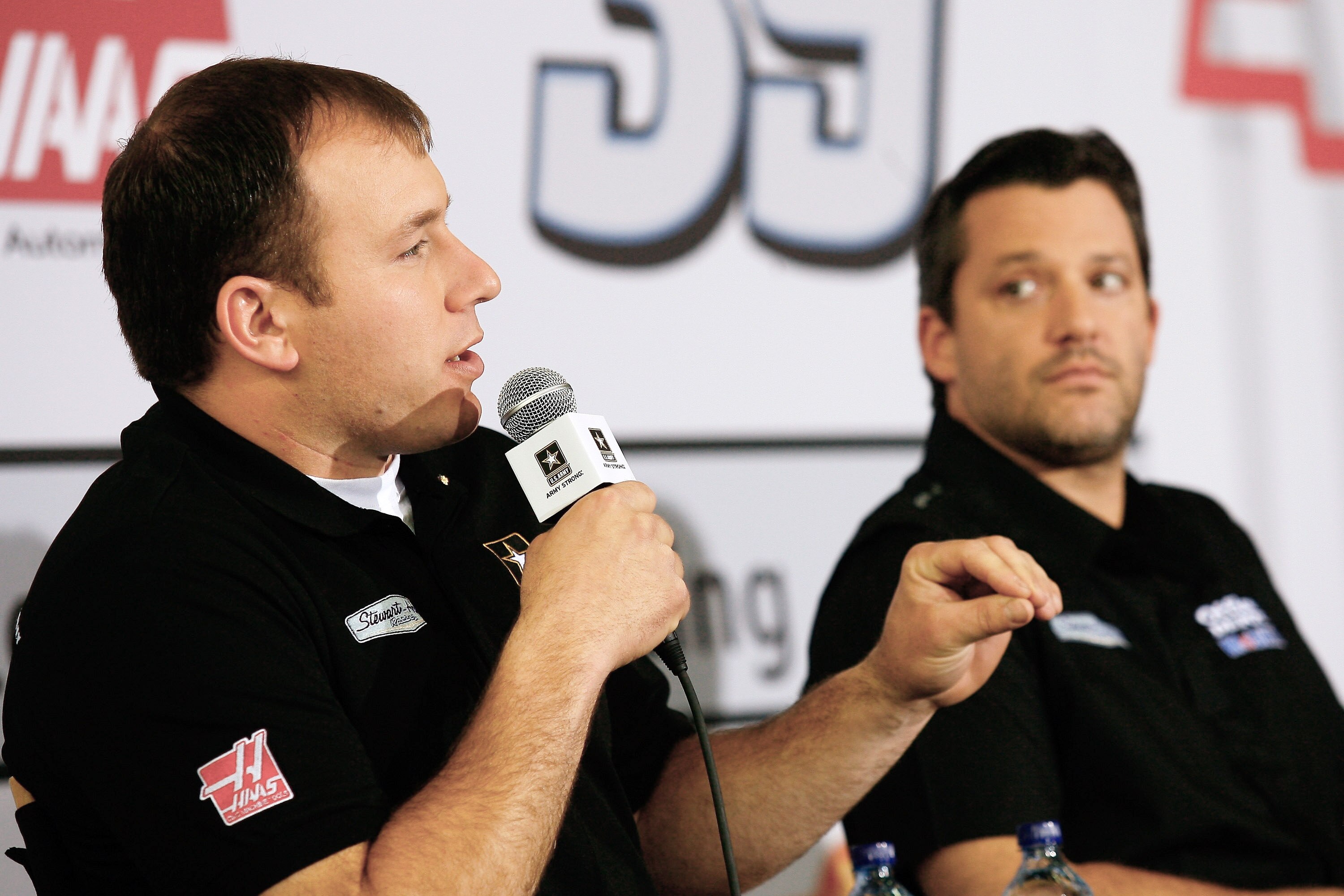 CHARLOTTE, NC - JANUARY 24: Ryan Newman (L), driver of the #14 U.S. ARMY Chevrolet, speaks to the media, as Tony Stewart (R), driver of the #14 Office Depot Chevrolet looks on, during the NASCAR Sprint Media Tour hosted by Charlotte Motor Speedway, held a