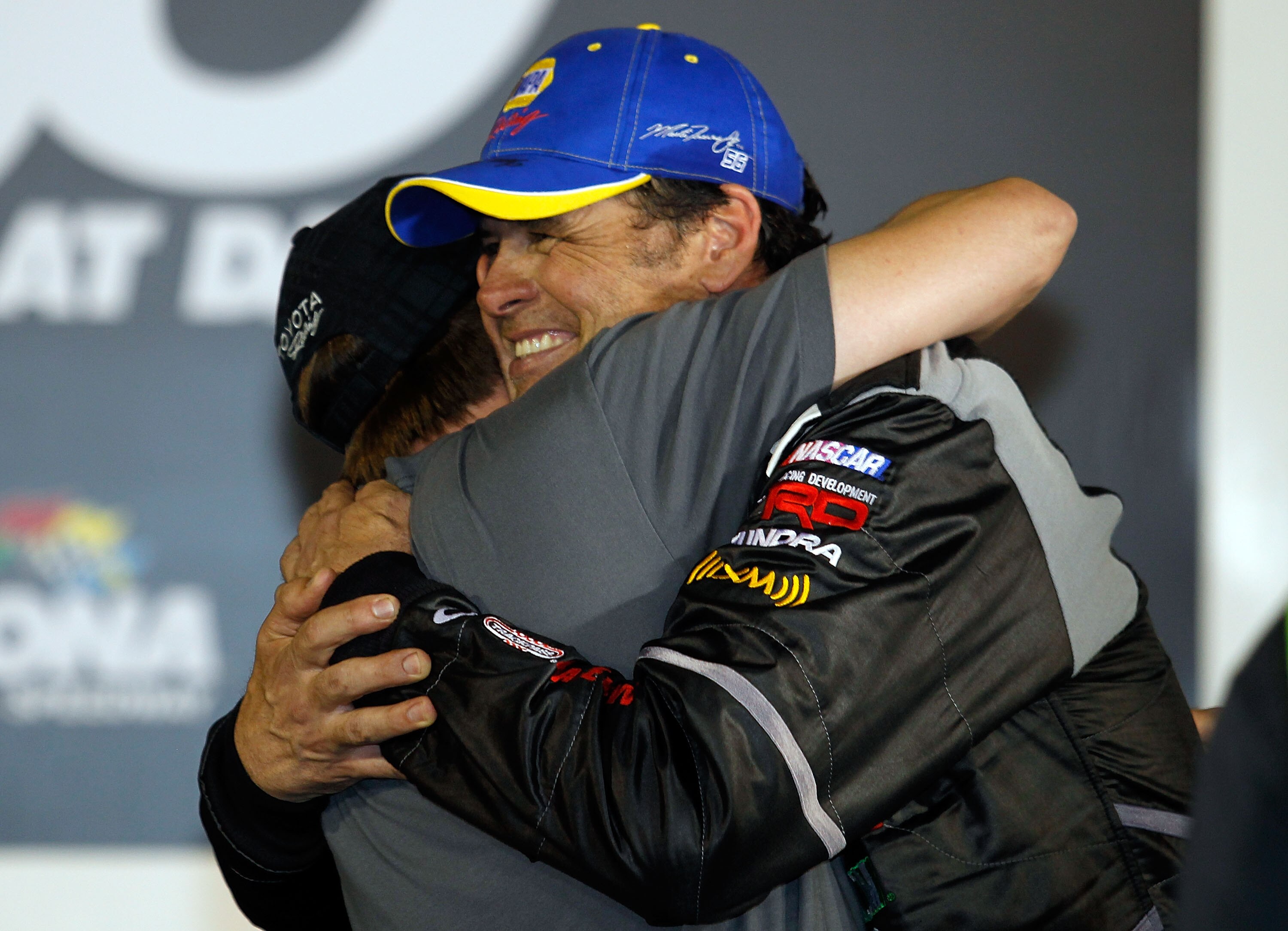 DAYTONA BEACH, FL - FEBRUARY 18:  Michael Waltrip (R), driver of the #15 NASCAR RACE View/Wounded Warrior Project Toyota, hugs driver David Reutimann (L) in Victory Lane after winning the NASCAR Camping World Truck Series NextEra Energy Resources 250 at D