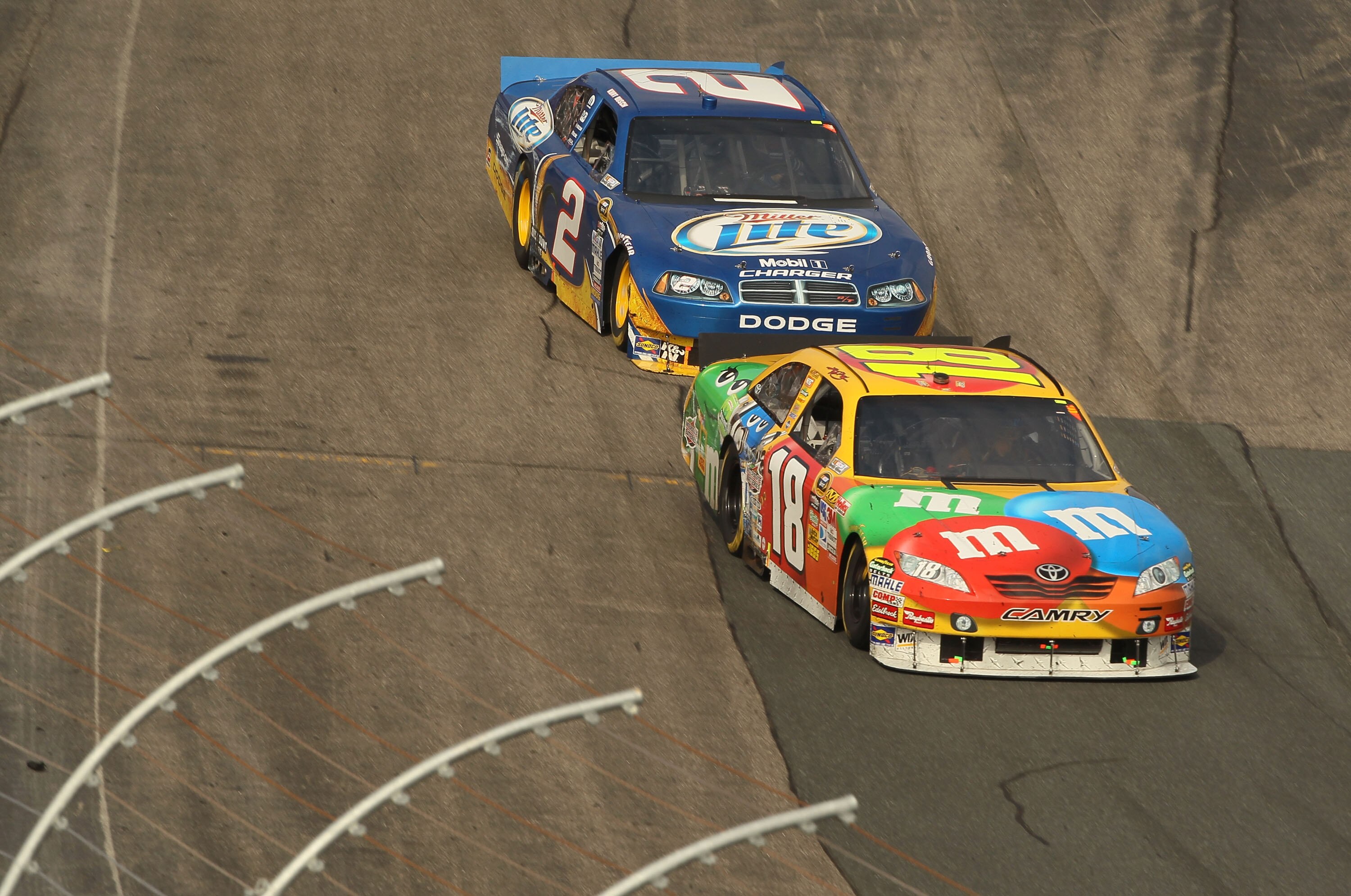 LOUDON, NH - SEPTEMBER 19:  Kyle Busch, driver of the #18 M&Ms Toyota races with Kurt Busch, driver of the #2 Miller Lite Dodge during the NASCAR Sprint Cup Series Sylvania 300 at New Hampshire Motor Speedway on September 19, 2010 in Loudon, New Hampshire
