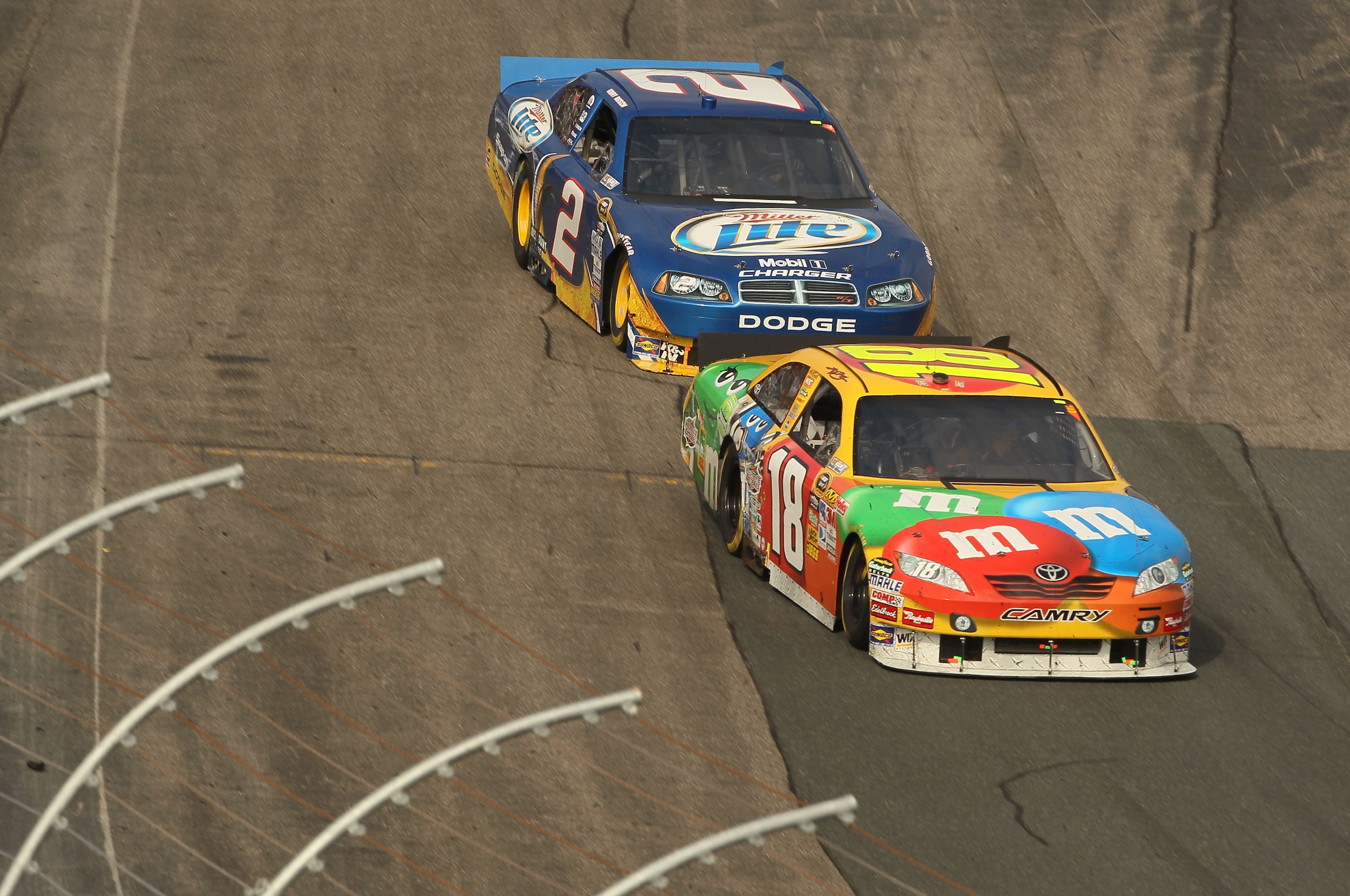 LOUDON, NH - SEPTEMBER 19:  Kyle Busch, driver of the #18 M&Ms Toyota races with Kurt Busch, driver of the #2 Miller Lite Dodge during the NASCAR Sprint Cup Series Sylvania 300 at New Hampshire Motor Speedway on September 19, 2010 in Loudon, New Hampshire