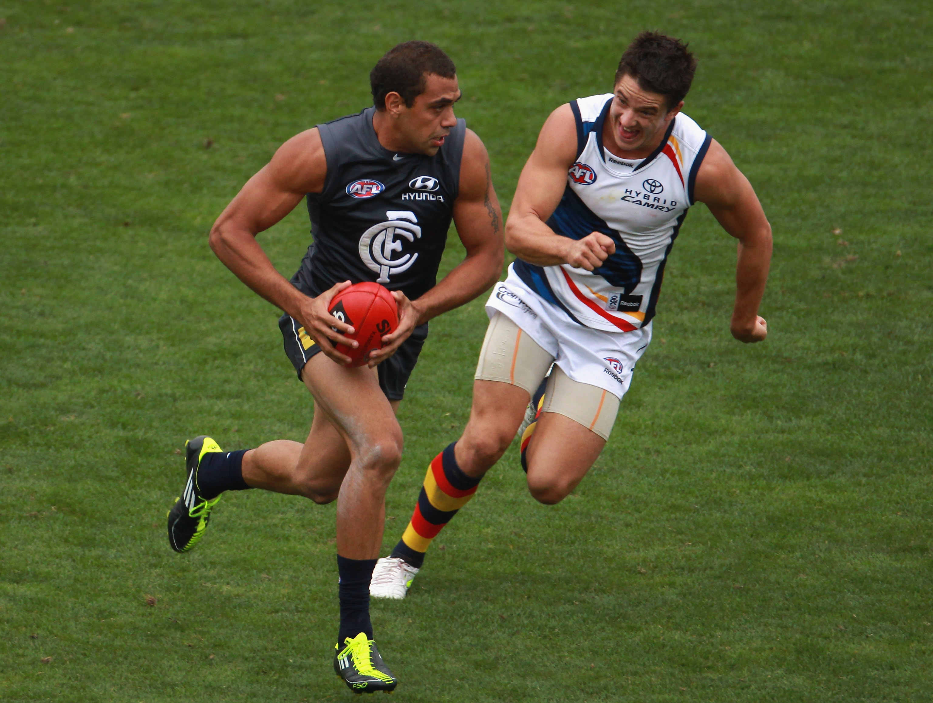 MELBOURNE, AUSTRALIA - MARCH 04: Chris Yarran of the Blues runs from his opponent during the NAB Challenge AFL match between the Carlton Blues and the Adelaide Crows at Visy Park on March 4, 2011 in Melbourne, Australia. (Photo by Robert Cianflone/Getty