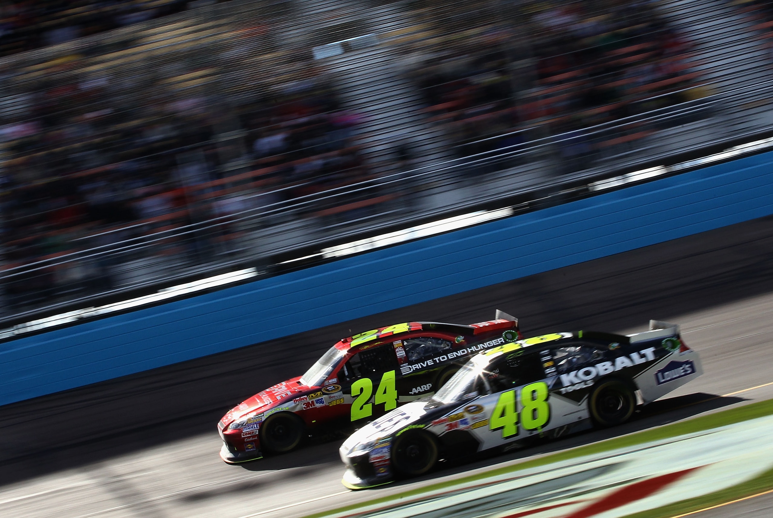 AVONDALE, AZ - FEBRUARY 27:  Jeff Gordon, driver of the #24 Drive to End Hunger Chevrolet, races Jimmie Johnson, driver of the #48 Lowe's Chevrolet, during the NASCAR Sprint Cup Series Subway Fresh Fit 500 at Phoenix International Raceway on February 27,