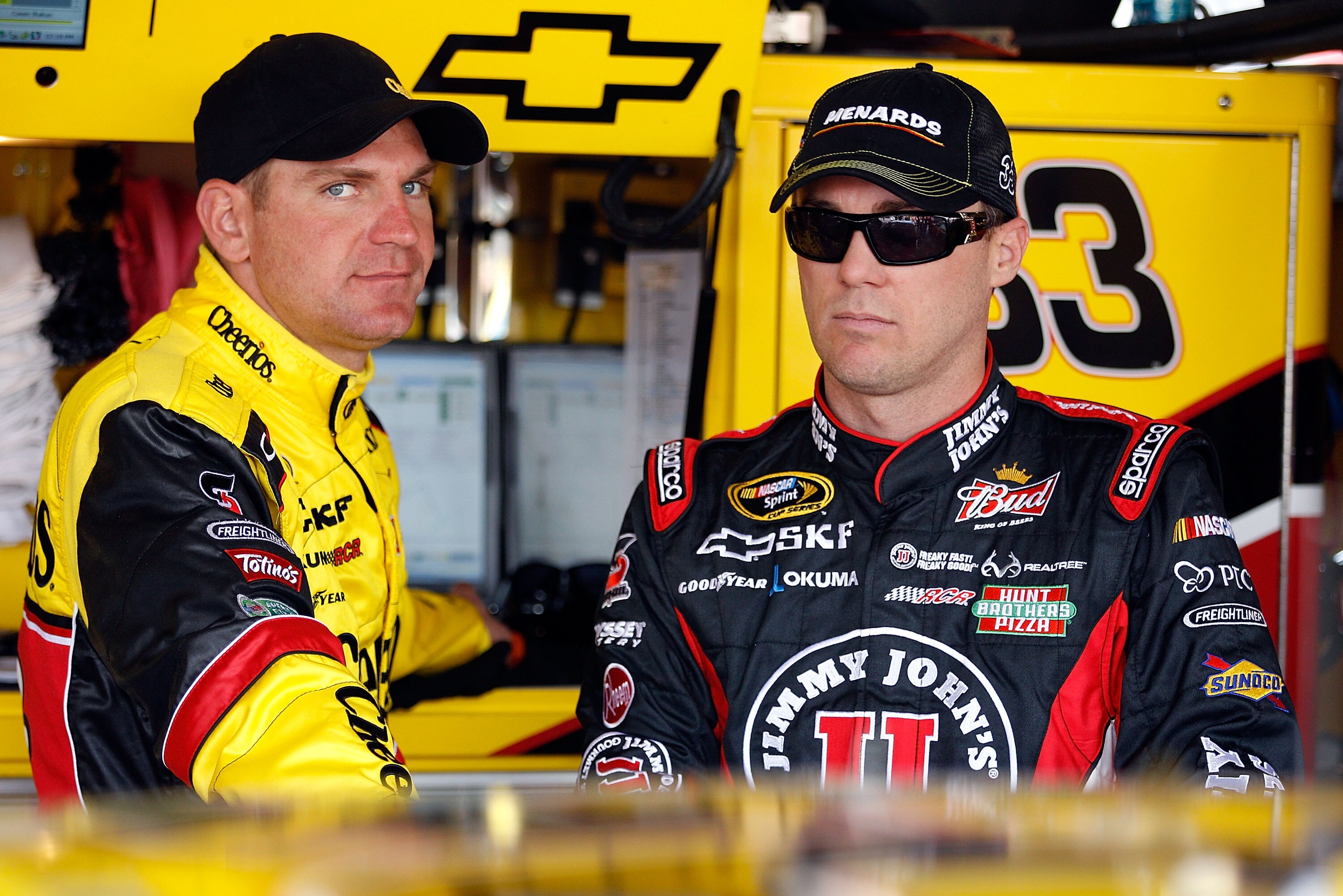 AVONDALE, AZ - FEBRUARY 25:  Clint Bowyer, driver of the #33 Cheerios Chevrolet, and Kevin Harvick, driver of the #29 Jimmy John's Chevrolet, stand in the garage area during practice for the Subway Fresh Fit 500 at Phoenix International Raceway on Februar