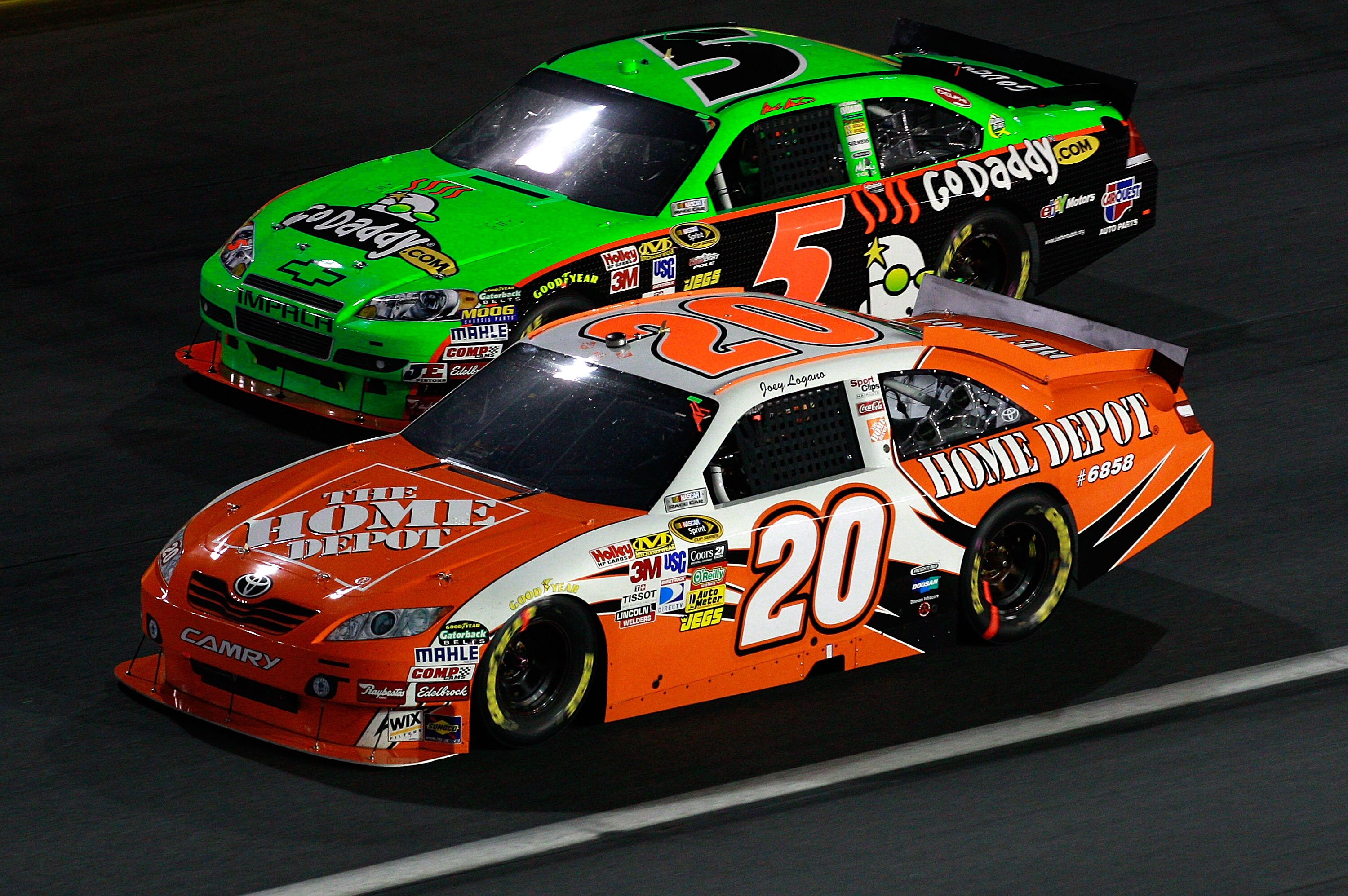 CONCORD, NC - OCTOBER 16:  Joey Logano, driver of the #20 Home Depot Toyota, races Mark Martin, driver of the #5 GoDaddy.com Chevrolet, during the NASCAR Sprint Cup Series Bank of America 500 at Charlotte Motor Speedway on October 16, 2010 in Concord, Nor