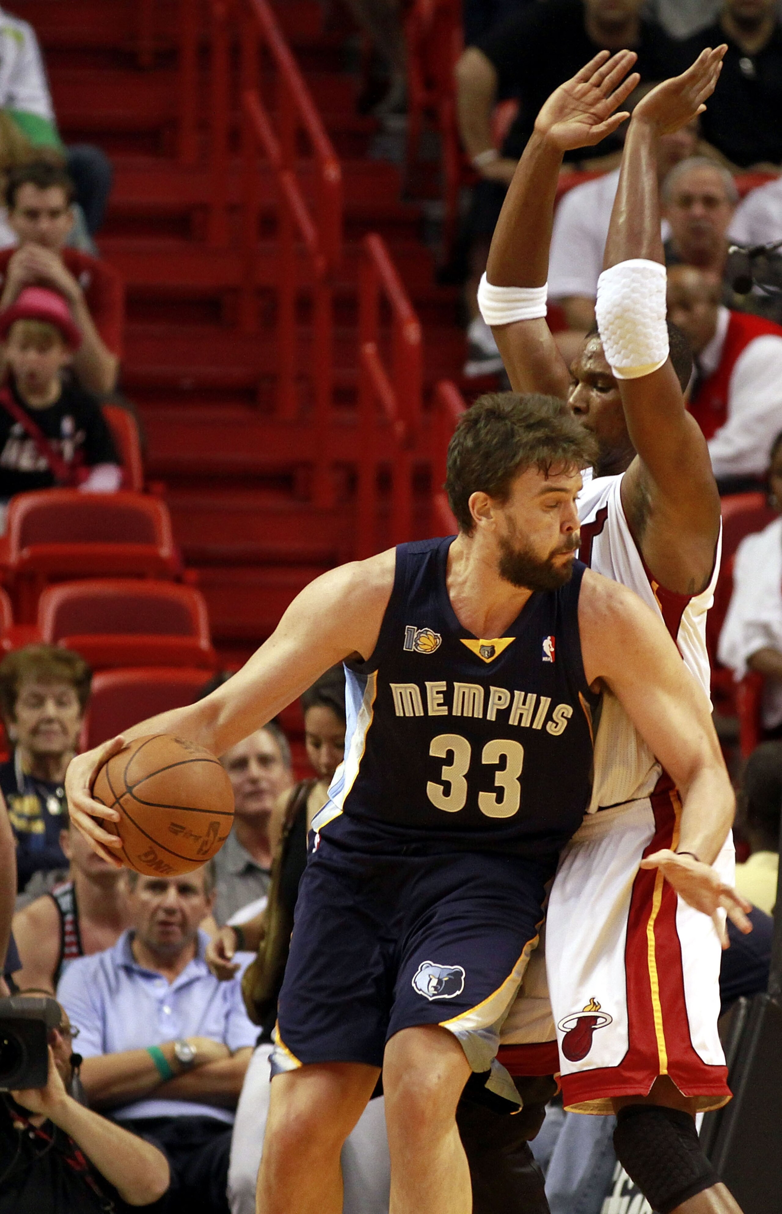 MIAMI - MARCH 12:  Forward Chris Bosh #1 of the Miami Heat defends against  Marc Gasol #33 of the Memphis Grizzlies at American Airlines Arena on March 12, 2011 in Miami, Florida. NOTE TO USER: User expressly acknowledges and agrees that, by downloading a