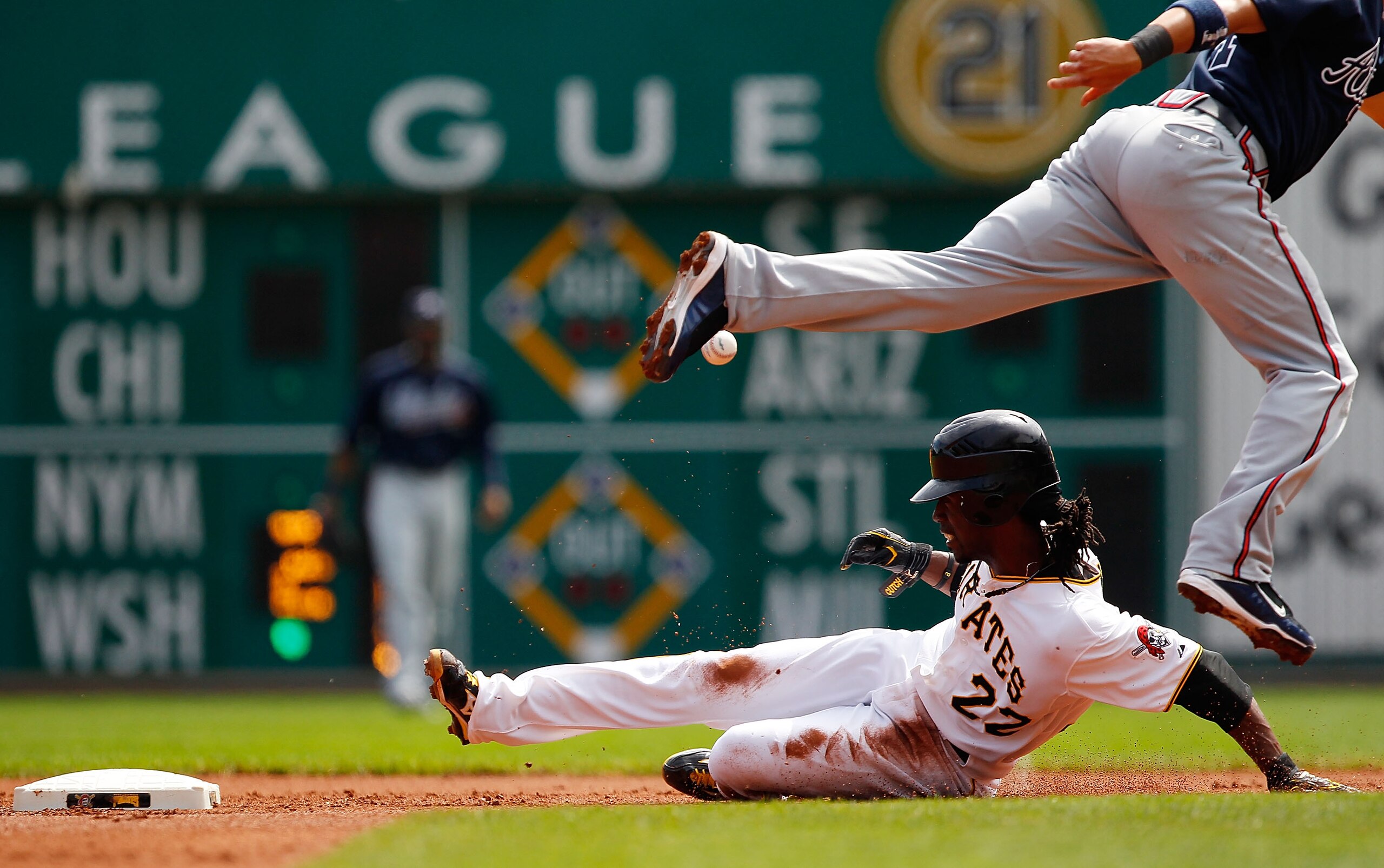 PITTSBURGH - SEPTEMBER 06:  Andrew McCutchen #22 of the Pittsburgh Pirates safely steals second base as the ball is thrown past Omar Infante #4 of the Atlanta Braves during the game on September 6, 2010 at PNC Park in Pittsburgh, Pennsylvania.  (Photo by