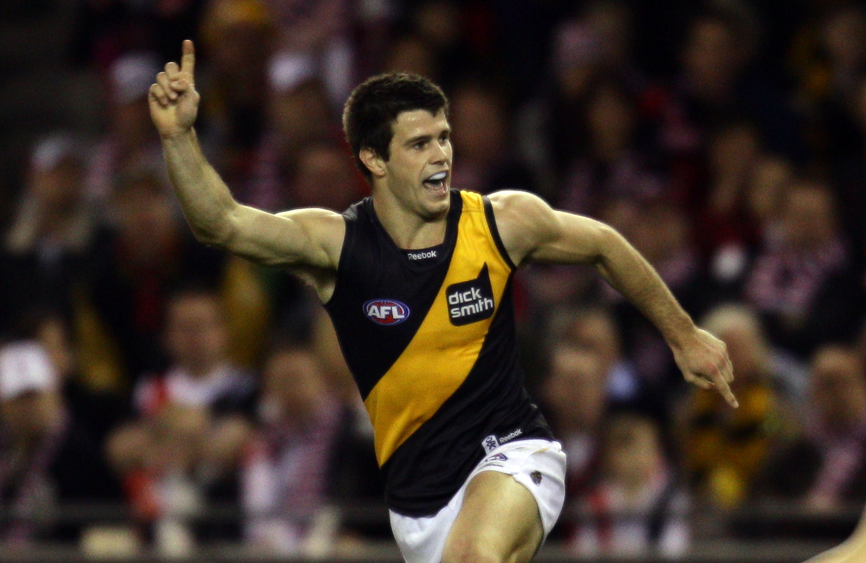MELBOURNE, AUSTRALIA - AUGUST 21: Trent Cotchin of the Tigers celebrates after kicking a goal during the round 21 AFL match between the St Kilda Saints and the Richmond Tigers at Etihad Stadium on August 21, 2010 in Melbourne, Australia. (Photo by Scott