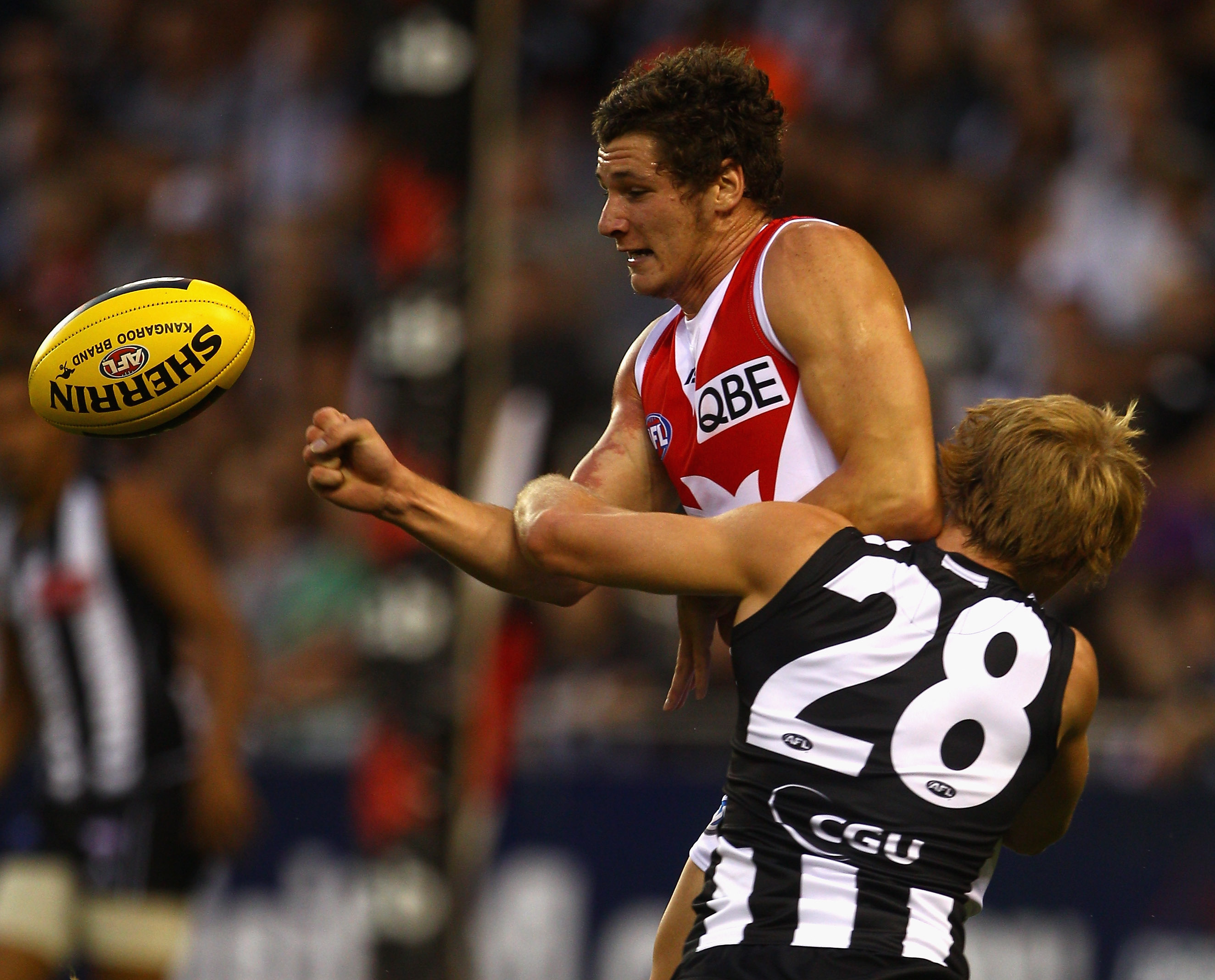 MELBOURNE, AUSTRALIA - FEBRUARY 25: Andrejs Everitt of the Swans is tackled by Ben Sinclair of the Magpies during the NAB Cup Quarter Final match between the Collingwood Magpies and the Sydney Swans at Etihad Stadium on February 25, 2011 in Melbourne, A