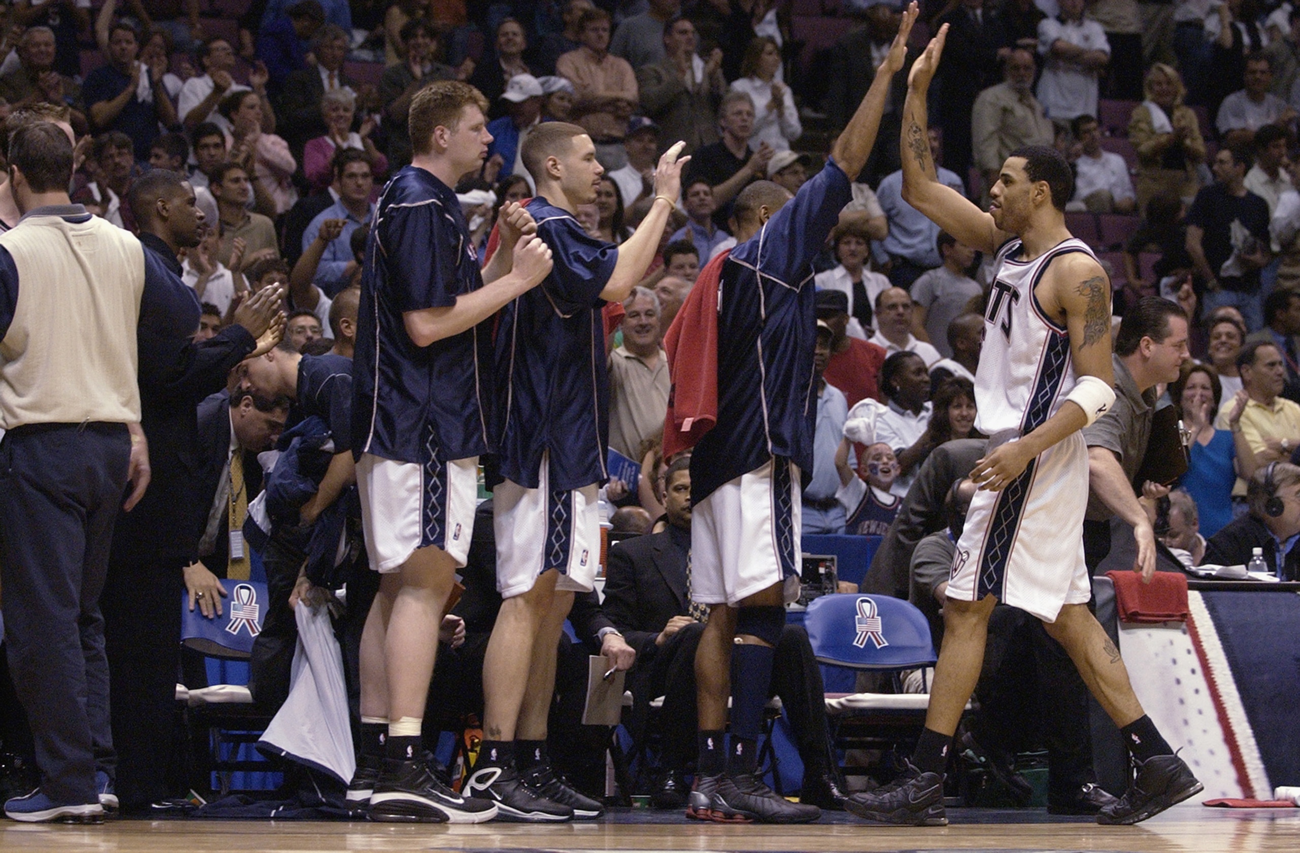EAST RUTHERFORD, NJ - MAY 29:  Forward Kenyon Martin #6 of the New Jersey Nets returns to congratulations from his teammates on the bench in Game five of the Eastern Conference Finals against the Boston Celtics during the 2002 NBA Playoffs at Continental