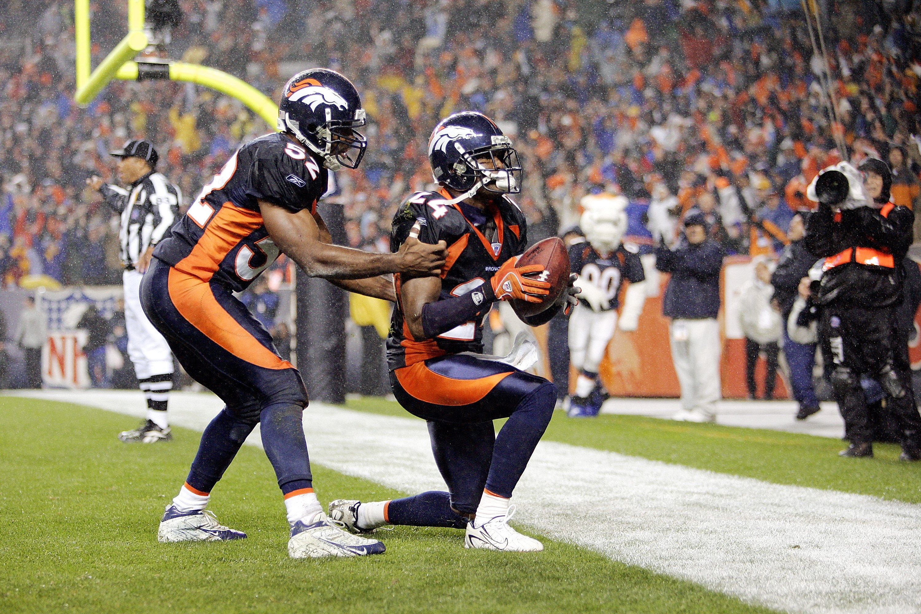 DENVER - OCTOBER 09:  Cornerback Champ Bailey #24 of the Denver Broncos is congratulated by teammate Ian Gold #52 after Bailey intercepted a pass intended for Clarence Moore of the Baltimore Ravens in the endzone for a touchback with 36 seconds remaining