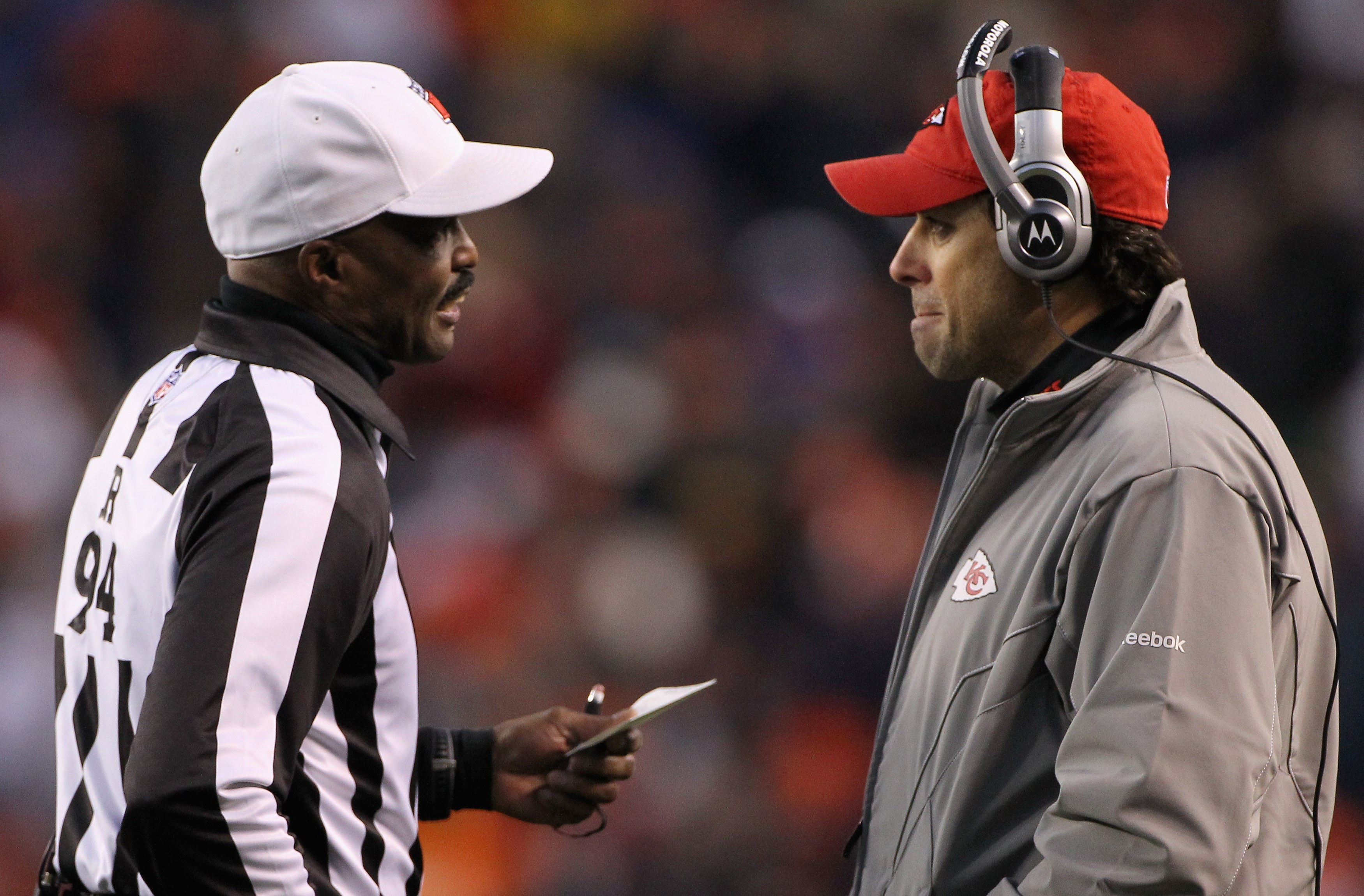DENVER - NOVEMBER 14:  Head coach Todd Haley of the Kansas City Chiefs questions a video replay call with referee Mike Carey on a touchdown by Brandon Lloyd of the Denver Broncos at INVESCO Field at Mile High on November 14, 2010 in Denver, Colorado. The