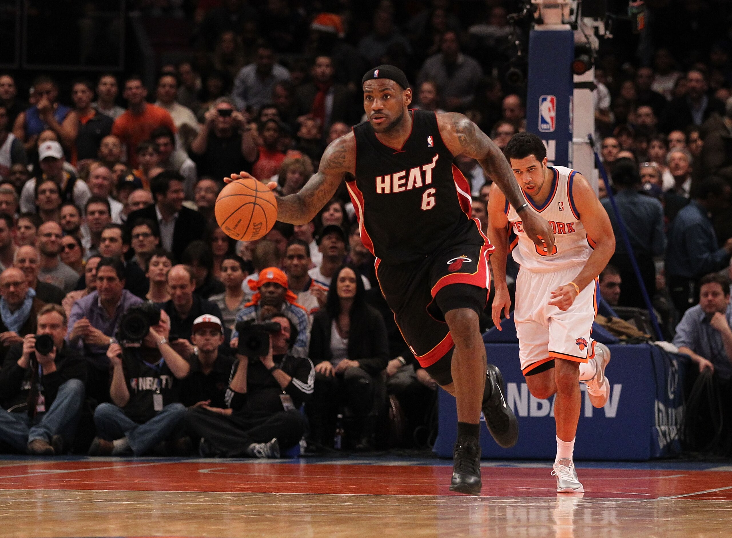 NEW YORK - DECEMBER 17:  LeBron James #6 of the Miami Heat dribbles the ball as Landry Fields #6 of the New York Knicks  gives chase at Madison Square Garden on December 17, 2010 in New York City. NOTE TO USER: User expressly acknowledges and agrees that,