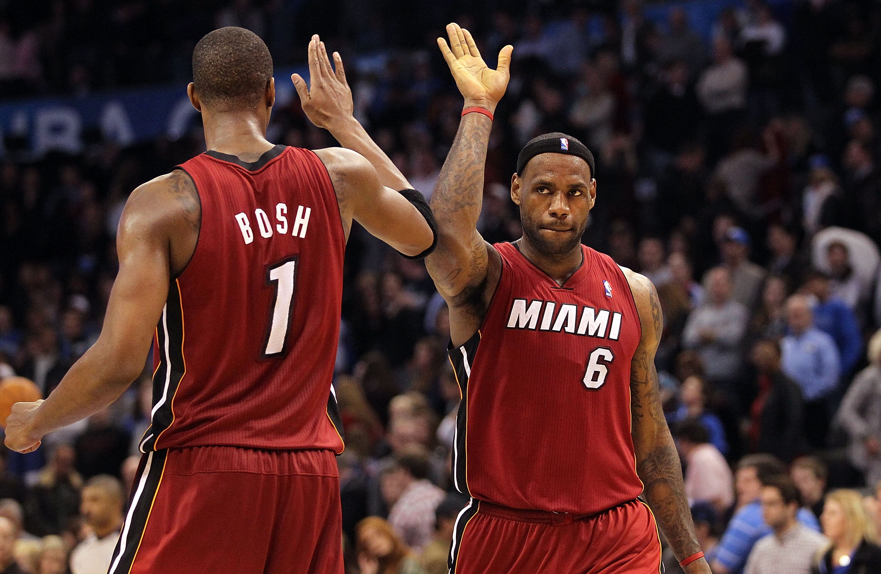 OKLAHOMA CITY, OK - JANUARY 30:  Forward LeBron James #6 and Chris Bosh #1 of the Miami Heat celebrate after a 108-103 win against the Oklahoma City Thunder at Ford Center on January 30, 2011 in Oklahoma City, Oklahoma.  NOTE TO USER: User expressly ackno