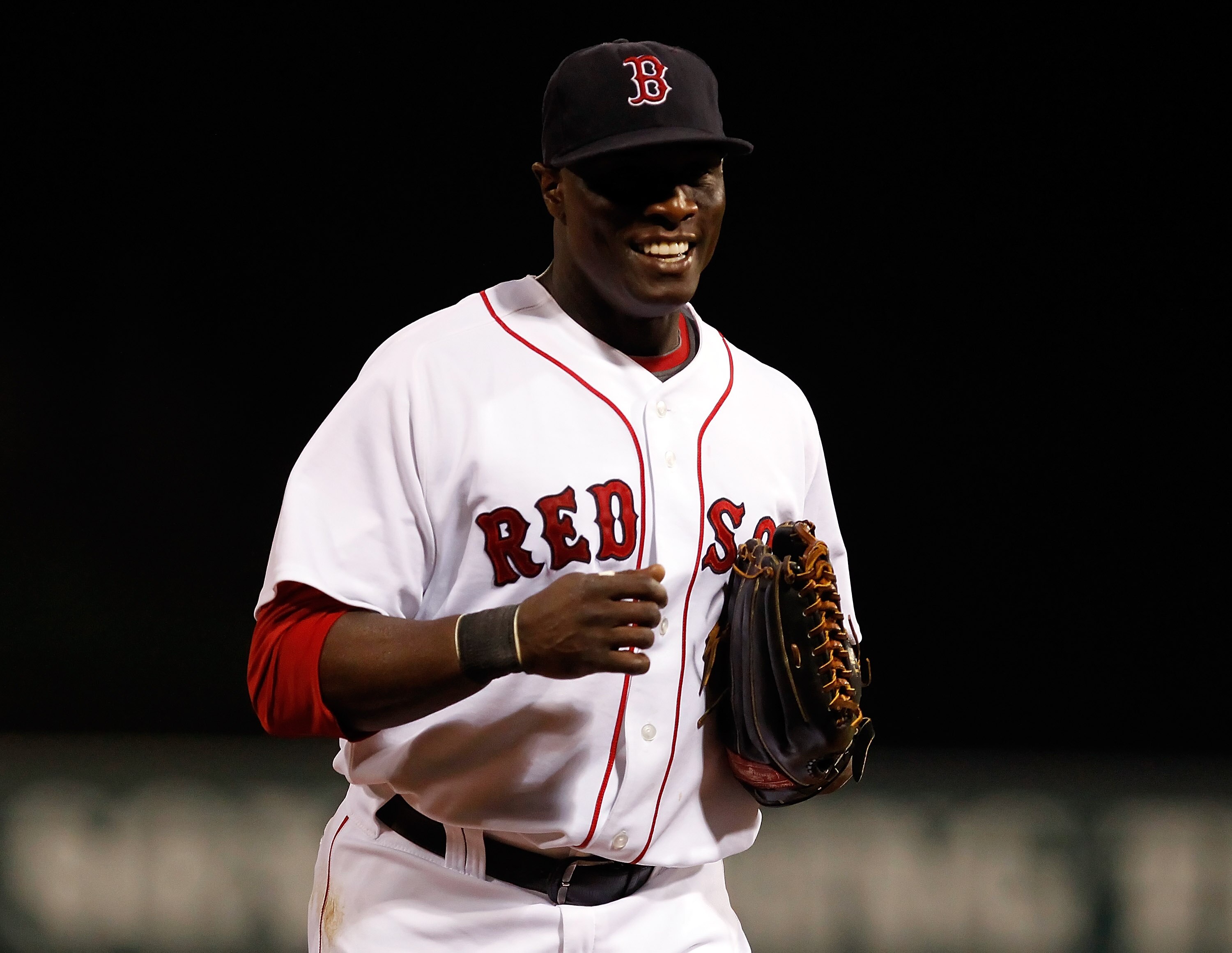 FORT MYERS, FL - MARCH 14:  Outfielder Mike Cameron #23 of the Boston Red Sox smiles as he returns to the dugout against the New York Yankees during a Grapefruit League Spring Training Game at City of Palms Park on March 14, 2011 in Fort Myers, Florida.