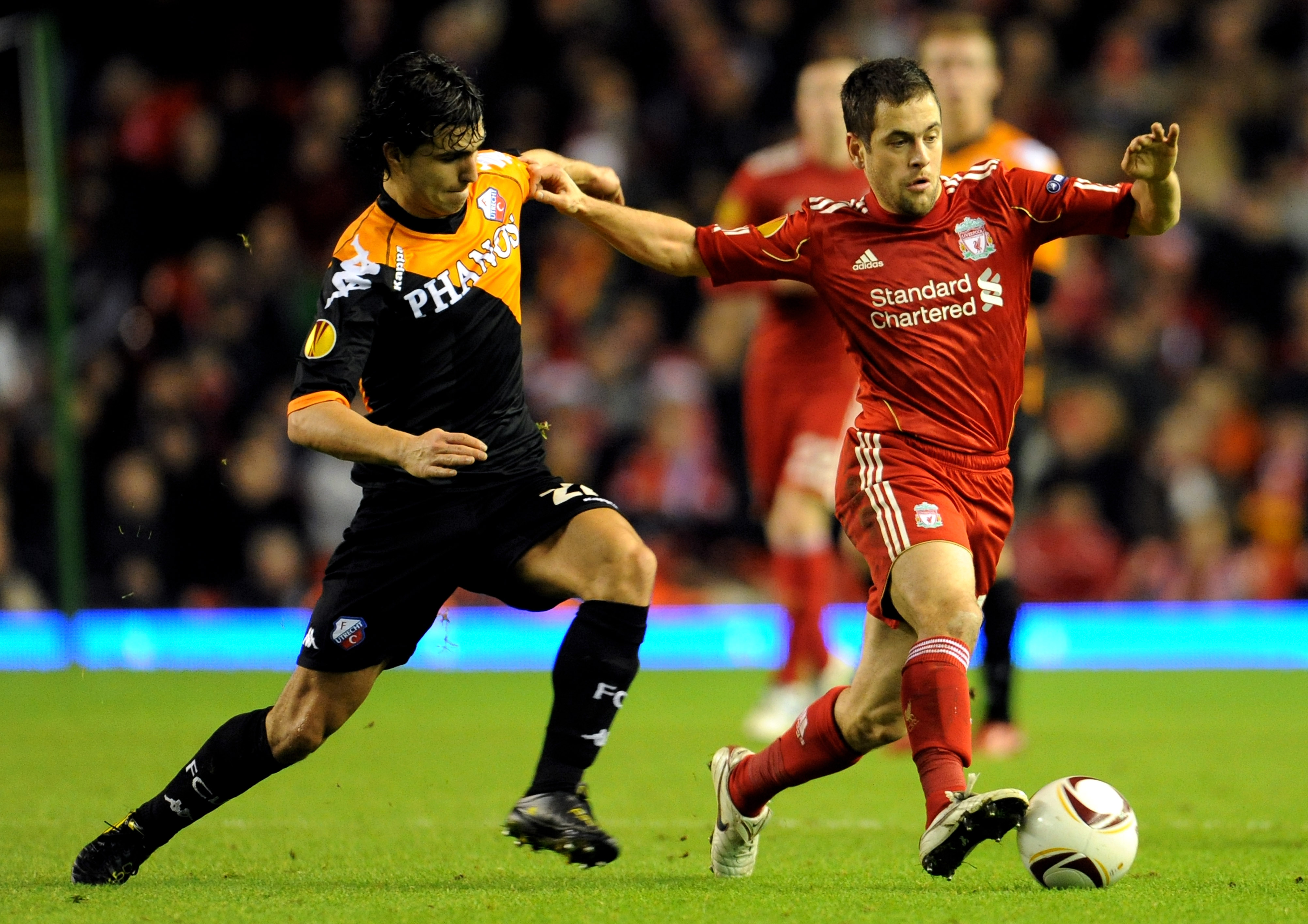 LIVERPOOL, ENGLAND - DECEMBER 15:  Joe Cole of Liverpool is challenged by Gianluca Nijholt of FC Utrecht during the UEFA Europa League Group K match between Liverpool and FC Utrecht at Anfield on December 15, 2010 in Liverpool, England.  (Photo by Clint H