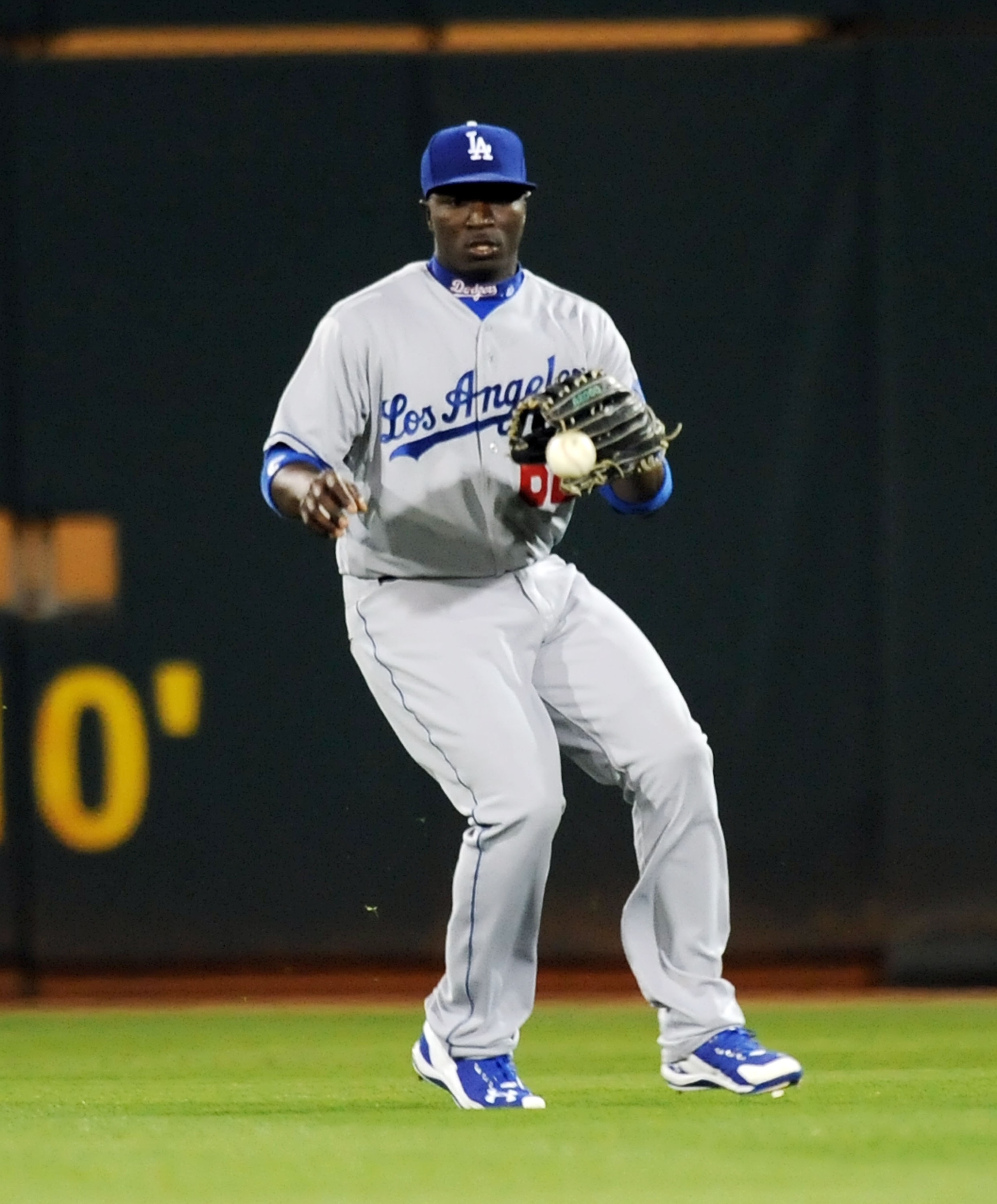 GOODYEAR, AZ - MARCH 03:  Trayvon Robinson #62 of the Los Angeles Dodgers fields a base hit against the Cincinnati Reds at Goodyear Ballpark on March 3, 2011 in Goodyear, Arizona.  (Photo by Norm Hall/Getty Images)