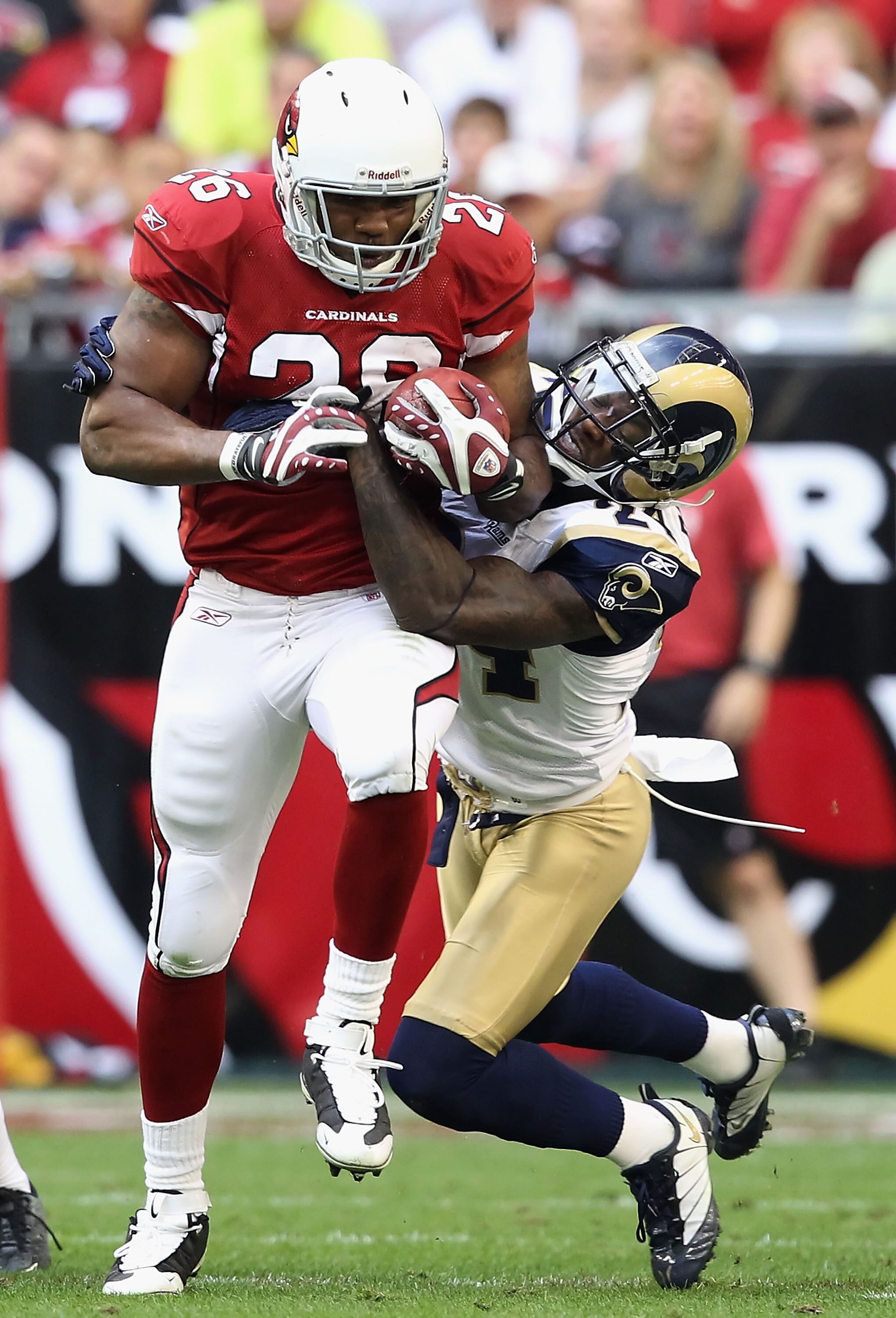 GLENDALE, AZ - DECEMBER 05:  Runningback Beanie Wells #26 of the Arizona Cardinals rushes the football against Ronald Bartell #24 of the St. Louis Rams during the NFL game at the University of Phoenix Stadium on December 5, 2010 in Glendale, Arizona.  The