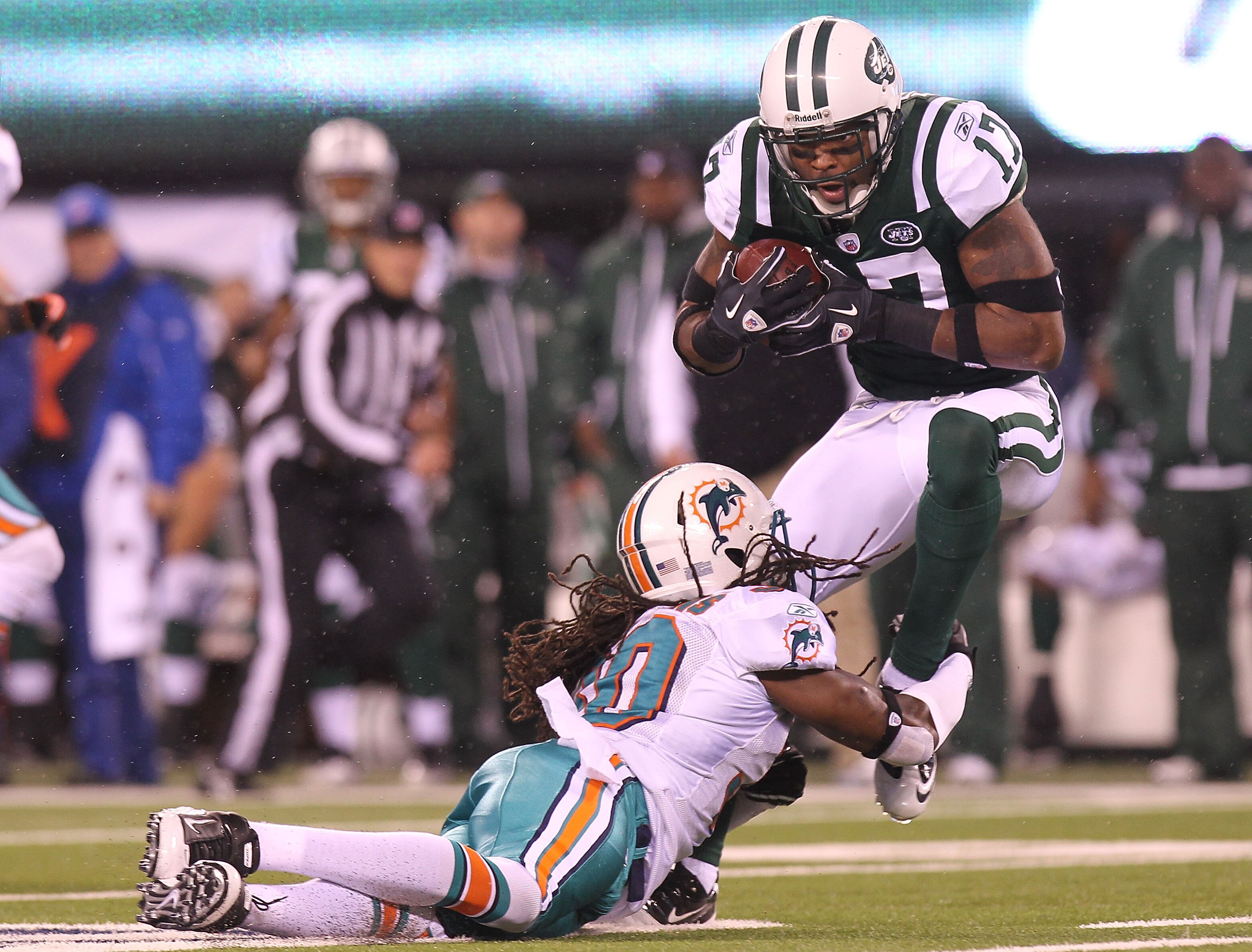 EAST RUTHERFORD, NJ - DECEMBER 12: Braylon Edwards #17 of the New York Jets is tackled by Chris  Clemons #30 of the Miami Dolphins at New Meadowlands Stadium on December 12, 2010 in East Rutherford, New Jersey.  (Photo by Nick Laham/Getty Images)