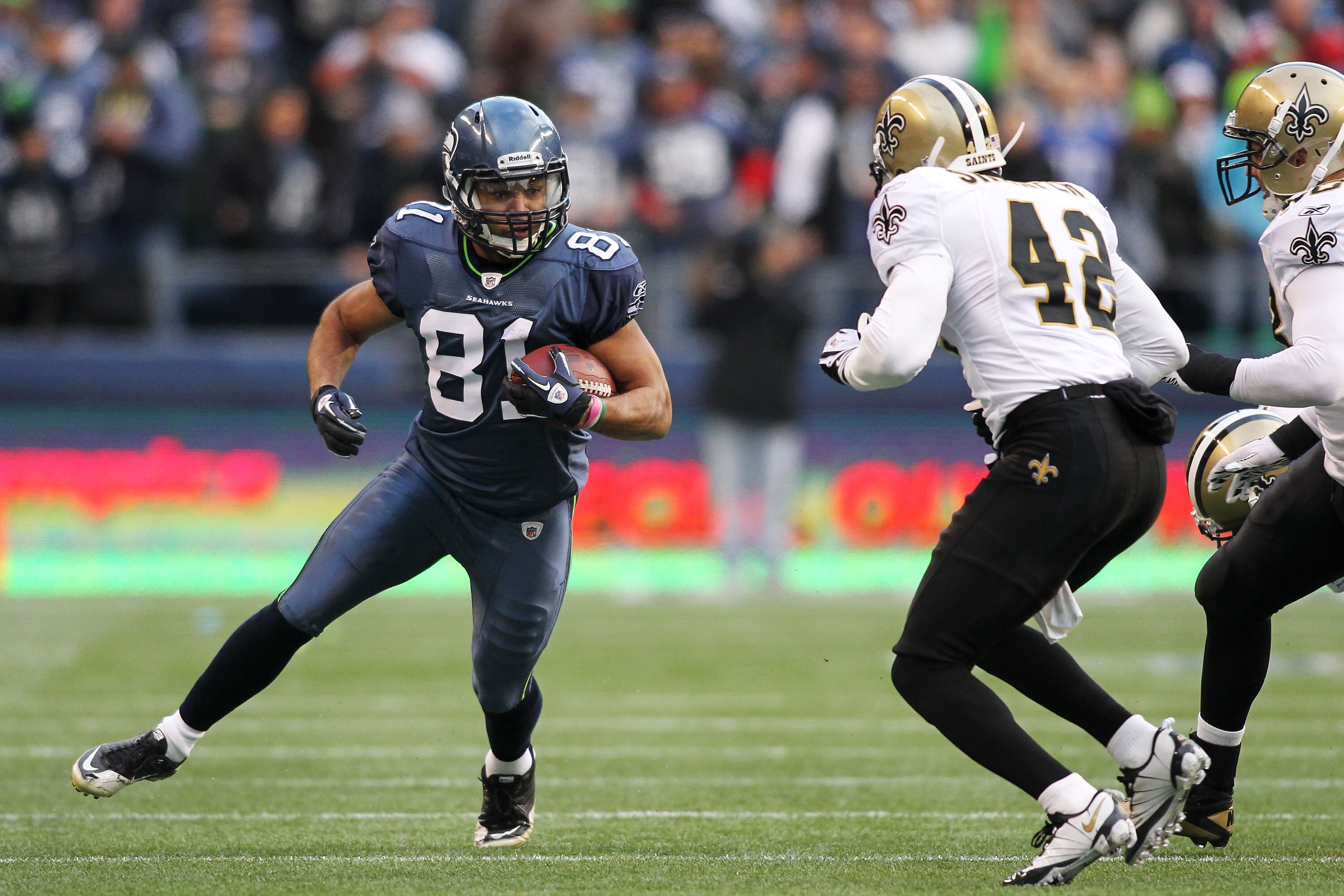 SEATTLE, WA - JANUARY 08:  Golden Tate #81 of the Seattle Seahawks runs down field against Darren Sharper #42 of the New Orleans Saints during the 2011 NFC wild-card playoff game at Qwest Field on January 8, 2011 in Seattle, Washington.  (Photo by Jonatha