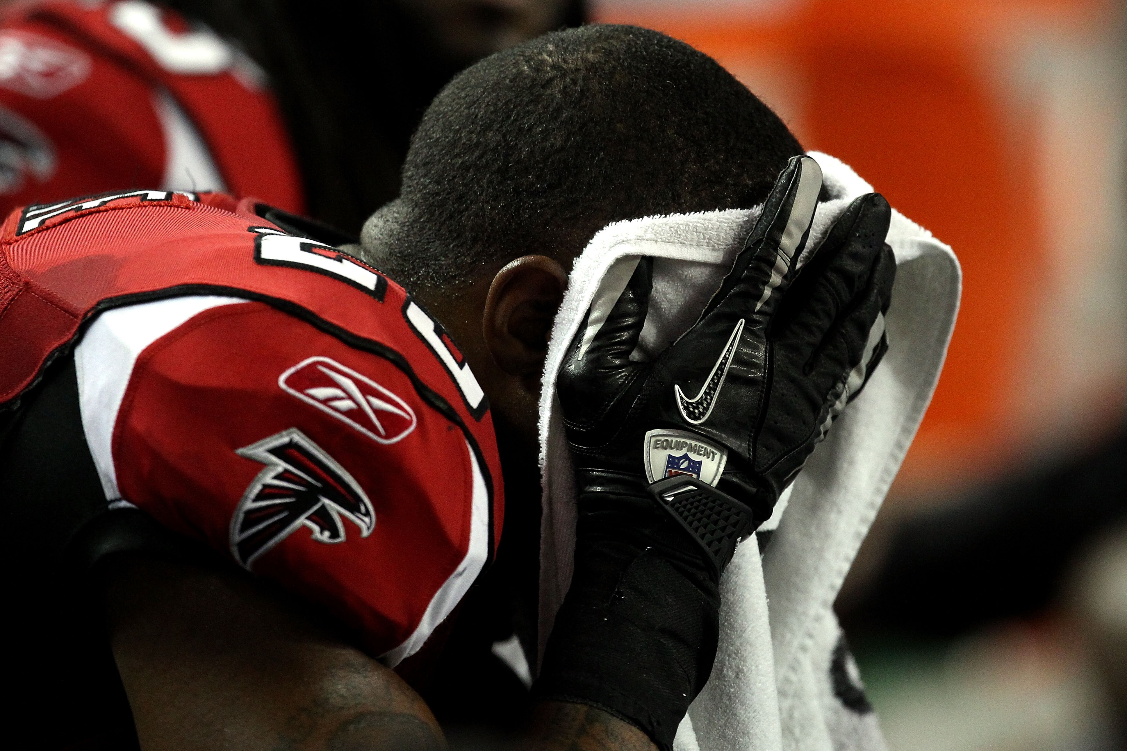 ATLANTA, GA - JANUARY 15:  William Moore #25 of the Atlanta Falcons covers his face with a towel on the bench against the Green Bay Packers during their 2011 NFC divisional playoff game at Georgia Dome on January 15, 2011 in Atlanta, Georgia. The Packers