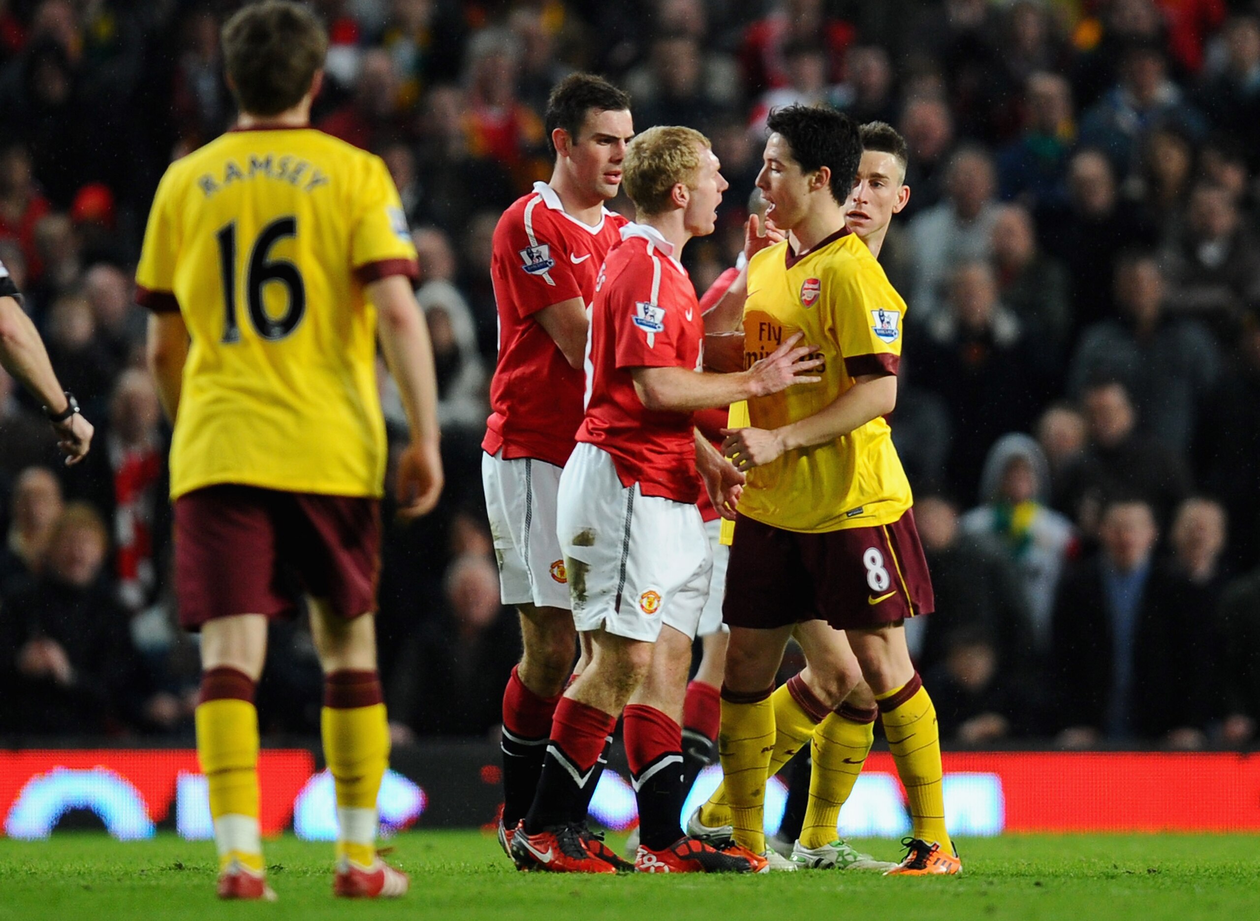 MANCHESTER, ENGLAND - MARCH 12:  Paul Scholes of Manchester United and Samir Nasri of Arsenal argue during the FA Cup sponsored by E.On Sixth Round match between Manchester United and Arsenal at Old Trafford on March 12, 2011 in Manchester, England.  (Pho