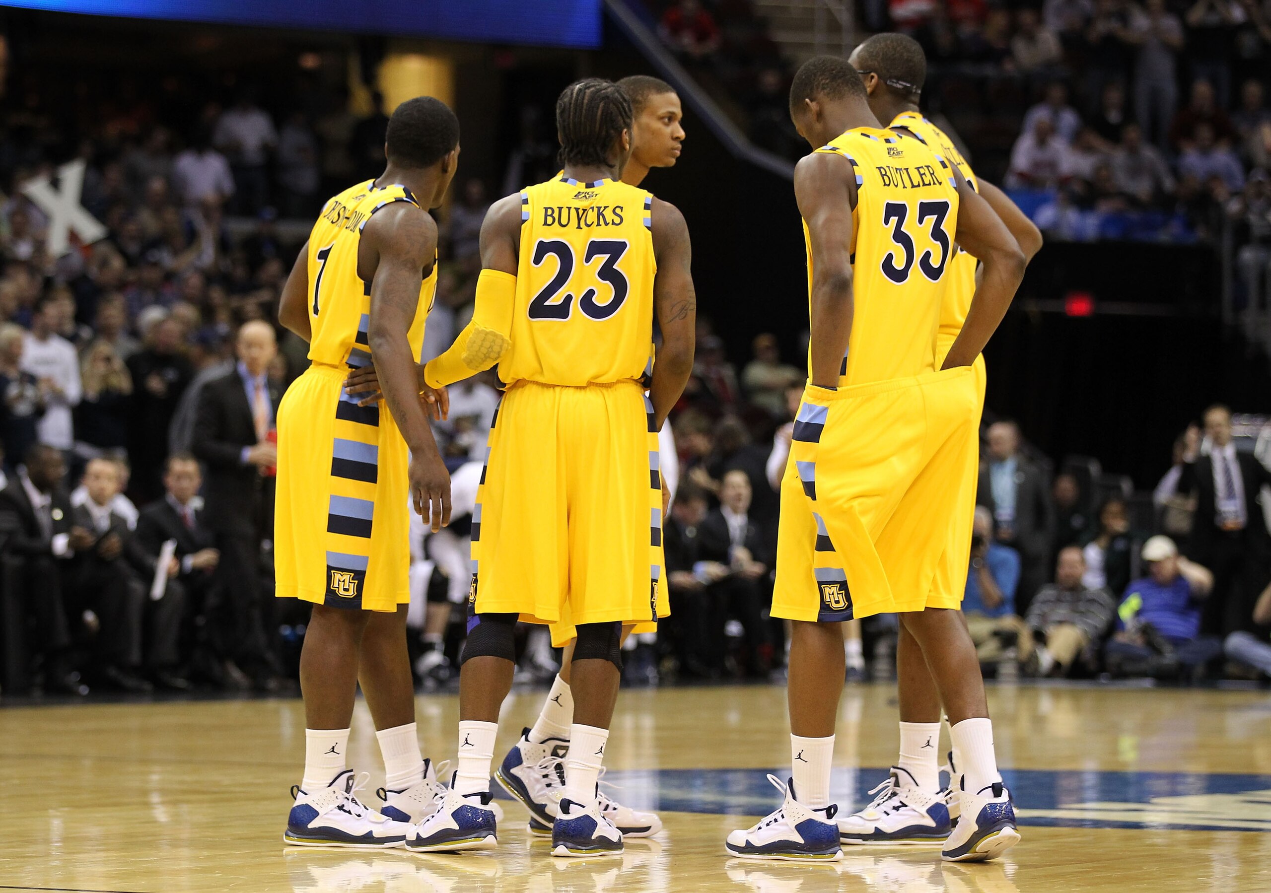 CLEVELAND, OH - MARCH 18: Darius Johnson-Odom #1, Dwight Buycks #23 and Jimmy Butler #33 of the Marquette Golden Eagles huddle with teammates during the game against the Xavier Musketeers during the second round of the 2011 NCAA men's basketball tournamen
