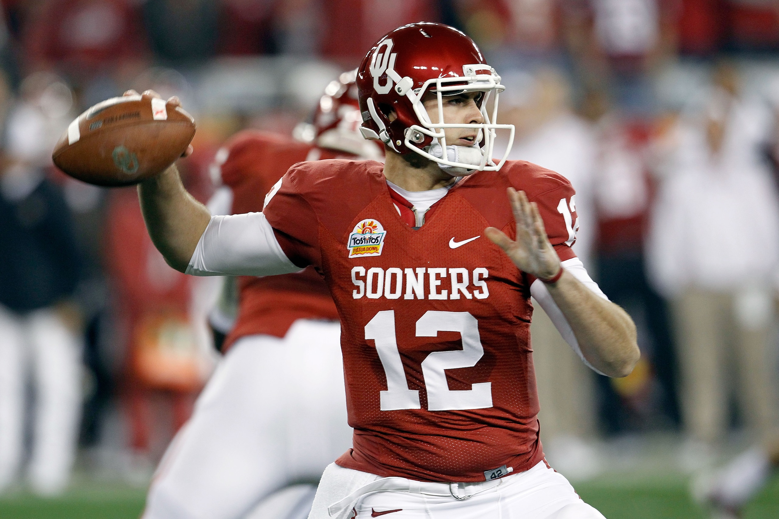 GLENDALE, AZ - JANUARY 01: Landry Jones #12 of the Oklahoma Sooners throws the ball in the first half against the Connecticut Huskies during the Tostitos Fiesta Bowl at the Universtity of Phoenix Stadium on January 1, 2011 in Glendale, Arizona. (Photo b GLENDALE, AZ - JANUARY 01: Landry Jones #12 of the Oklahoma Sooners throws the ball in the first half against the Connecticut Huskies during the Tostitos Fiesta Bowl at the Universtity of Phoenix Stadium on January 1, 2011 in Glendale, Arizona. (Photo b