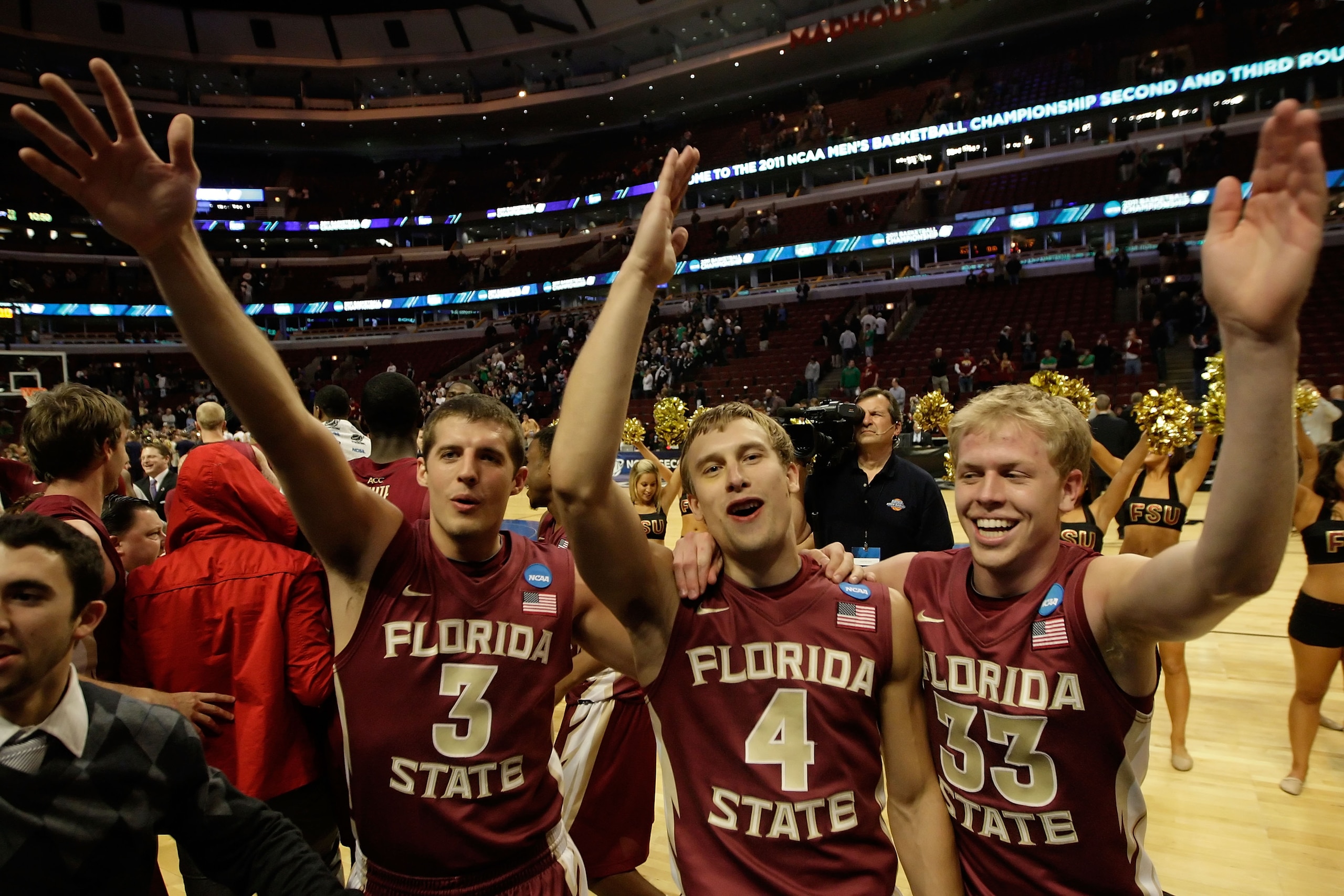 CHICAGO, IL - MARCH 20:  Luke Loucks #3, Deividas Dulkys #4 and Joey Moreau #33 of the Florida State Seminoles celebrate their 71-57 victory over the Notre Dame Fighting Irish during the third round of the 2011 NCAA men's basketball tournament at the Unit