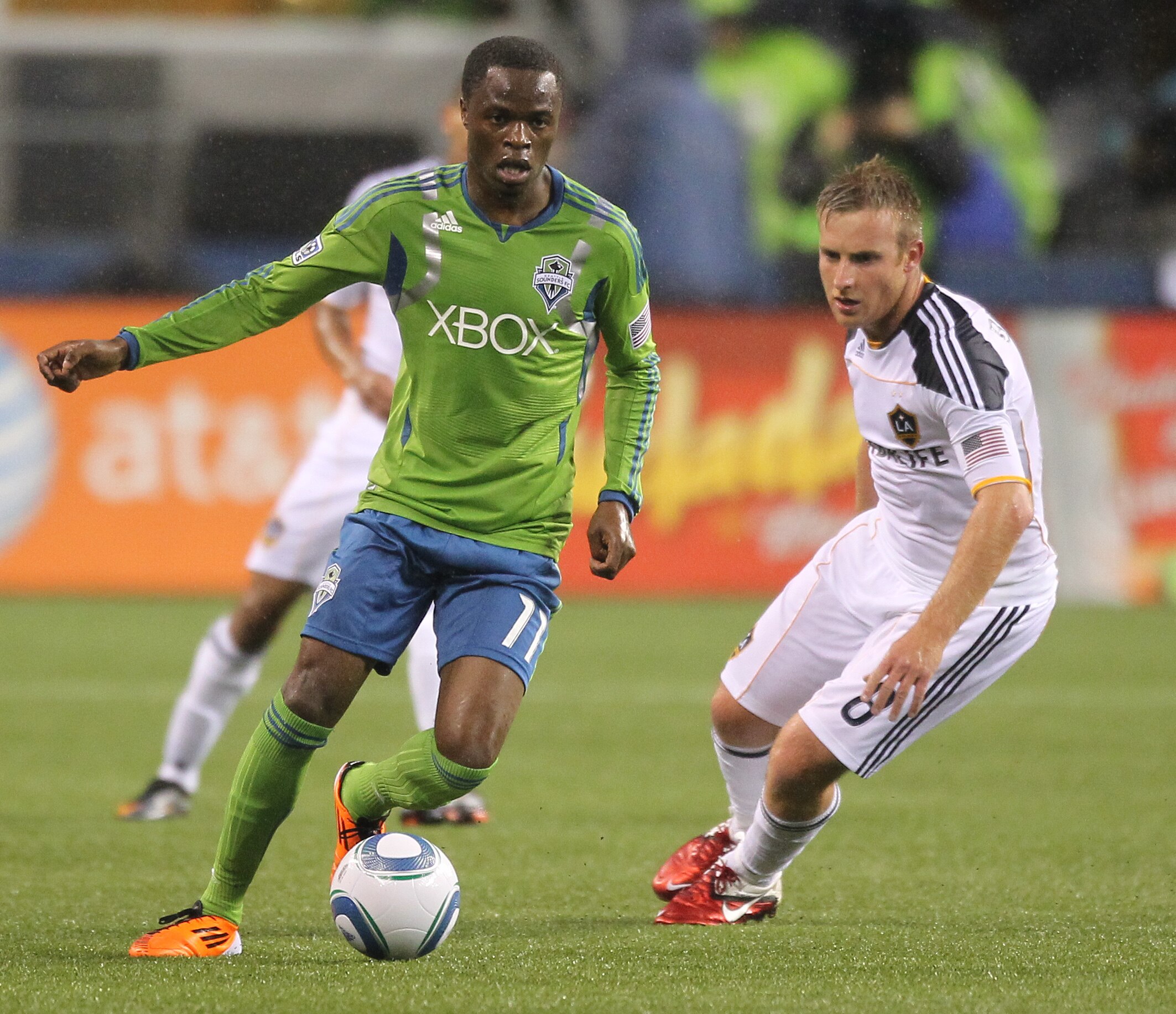 SEATTLE, WA - MARCH 15:  Steve Zakuani #11 of the Seattle Sounders FC dribbles against Chris Birchall #8 of the Los Angeles Galaxy at Qwest Field on March 15, 2011 in Seattle, Washington. (Photo by Otto Greule Jr/Getty Images)
