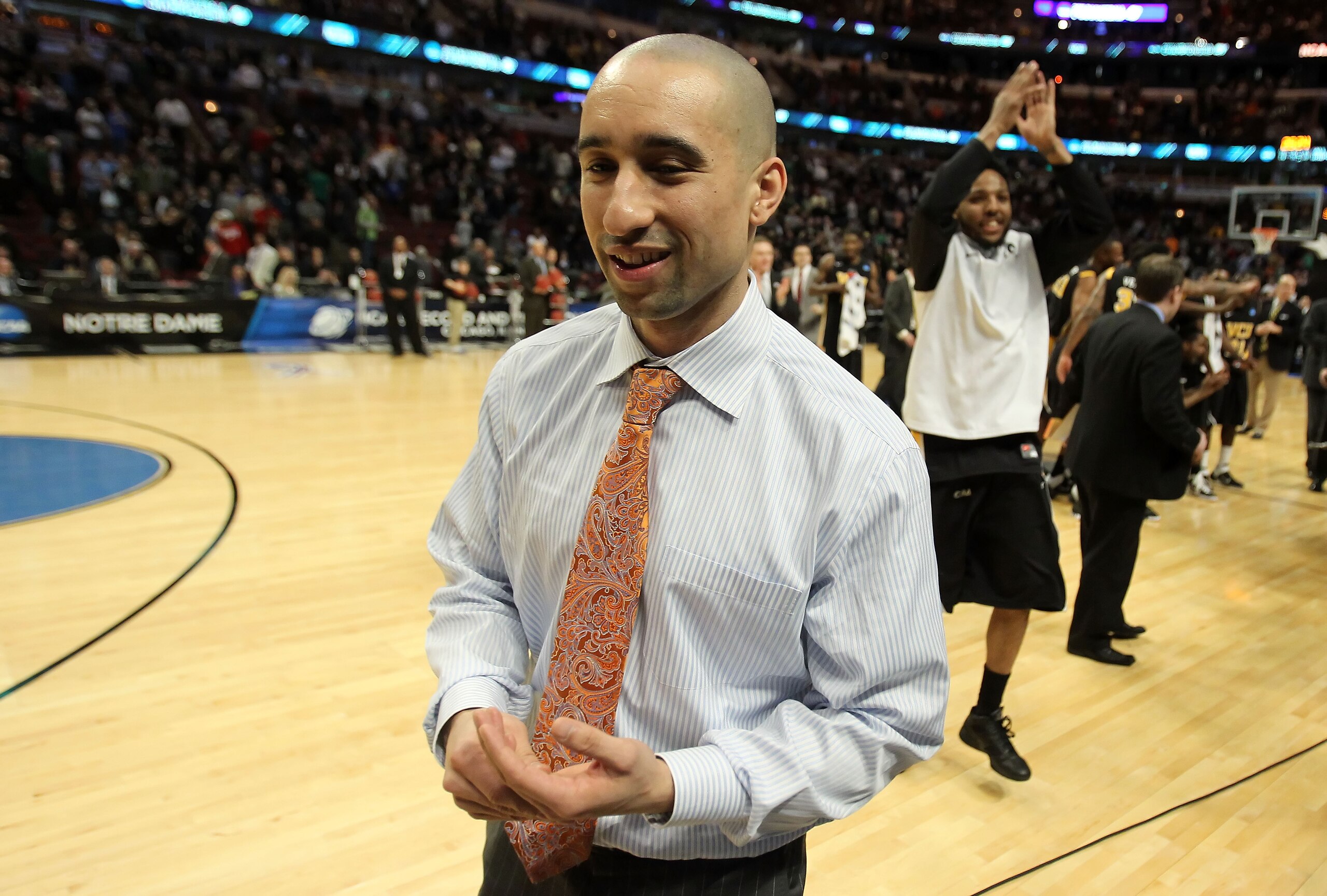 CHICAGO, IL - MARCH 20:  Head coach Shaka Smart of the Virginia Commonwealth Rams walks off court as Brandon Rozzell #32 celebrates defeating the Purdue Boilermakers during the third round of the 2011 NCAA men's basketball tournament at the United Center