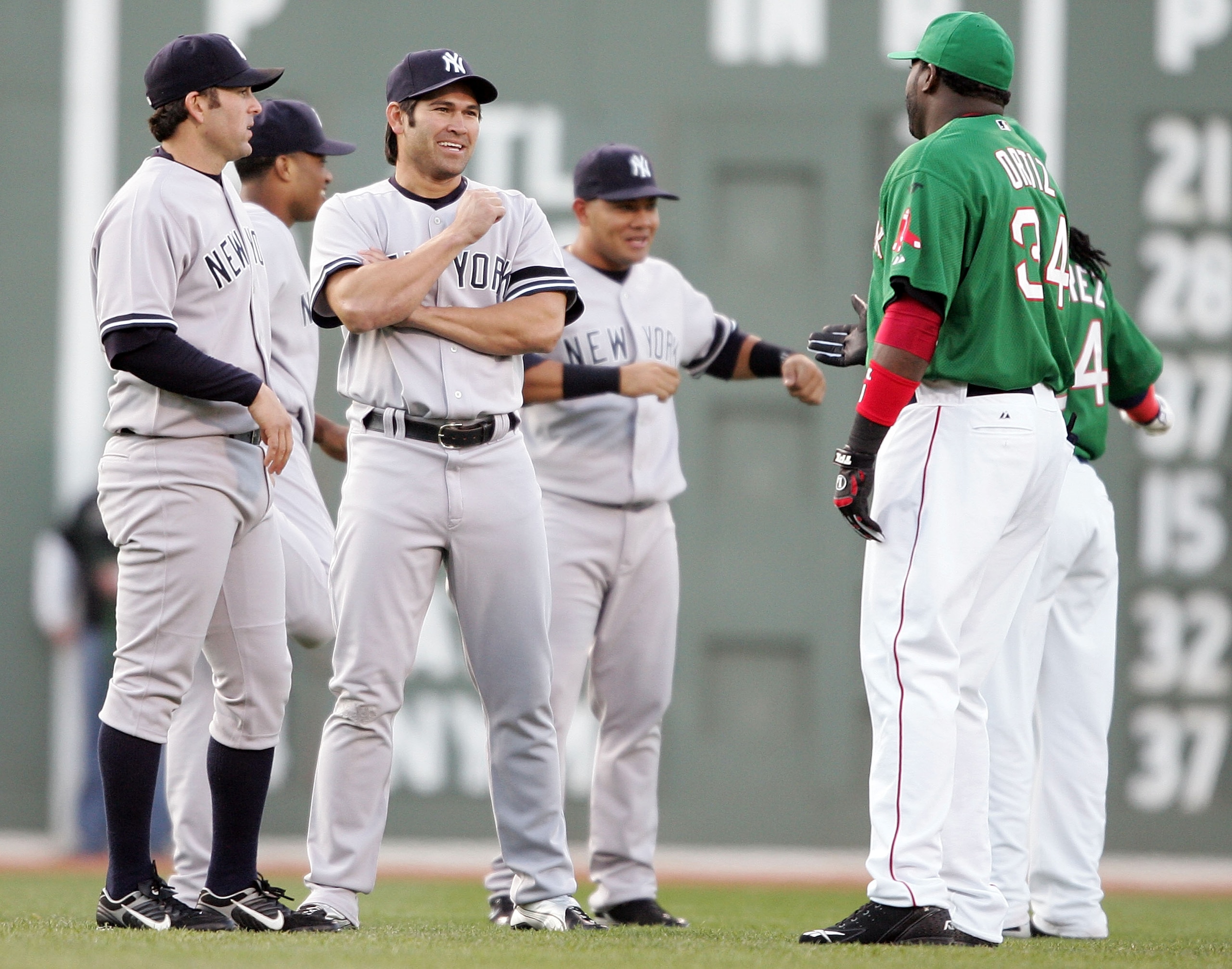 BOSTON - APRIL 20:  Doug Mientkiewicz #11 and Johnny Damon #18 of the New York Yankees catches up with his old teammates David Ortiz #34 and Manny Ramirez #24 of the Boston Red Sox before the game on April 20, 2007 at Fenway Park in Boston, Massachusetts.