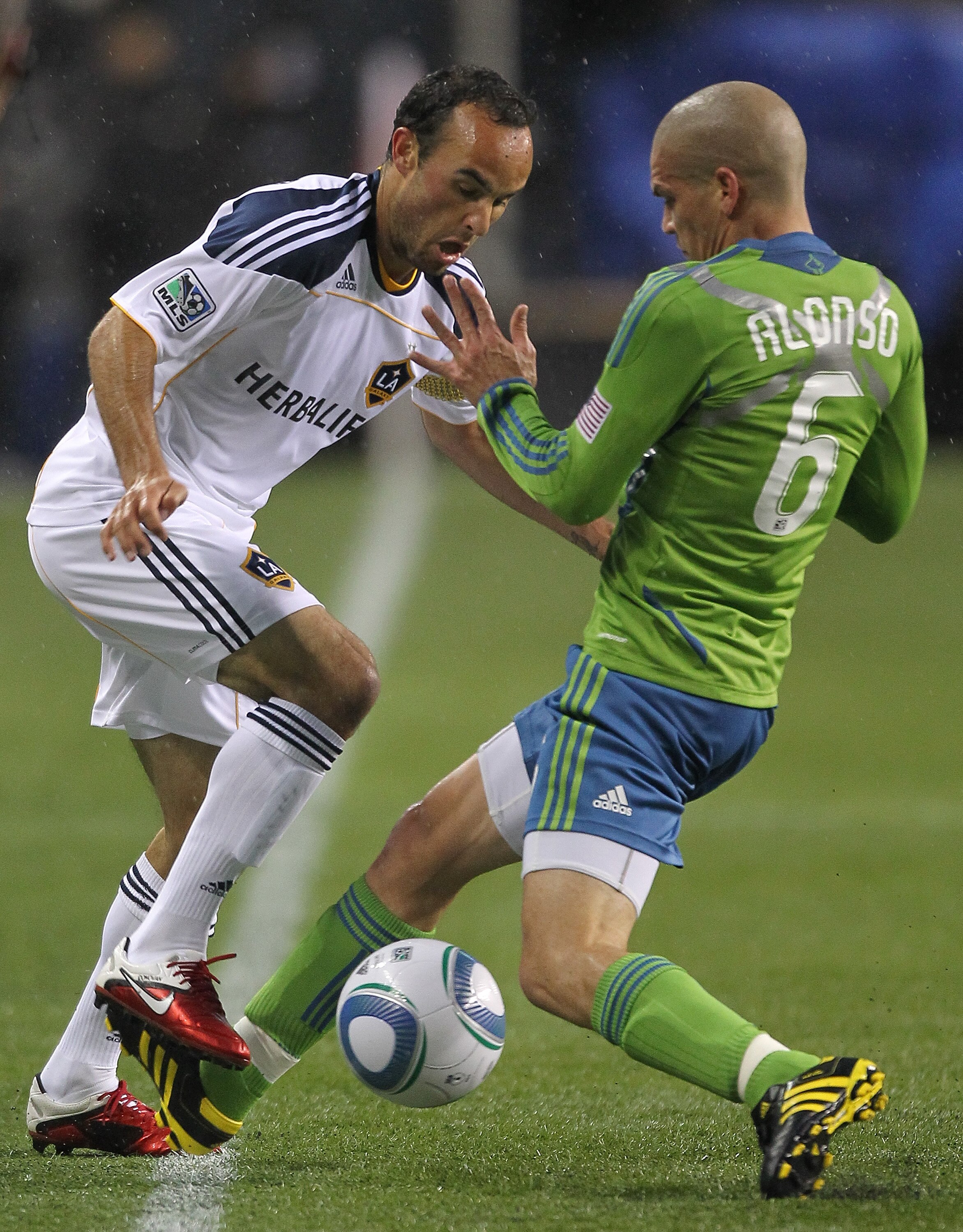 SEATTLE - MARCH 15:  Landon Donovan #10 of the Los Angeles Galaxy battles Osvaldo Alonso #6 of the Seattle Sounders FC at Qwest Field on March 15, 2011 in Seattle, Washington. (Photo by Otto Greule Jr/Getty Images)