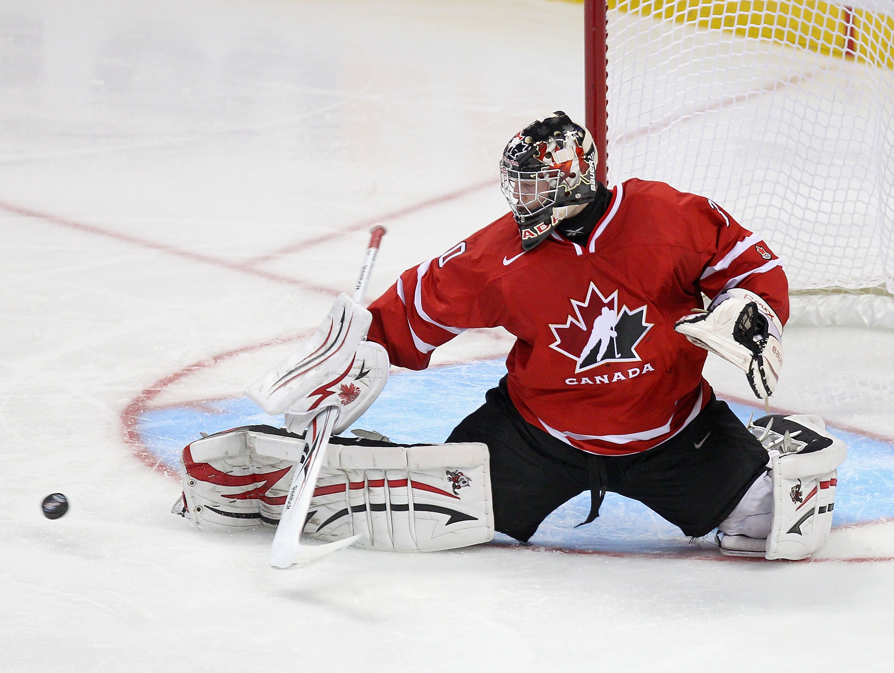 BUFFALO, NY - JANUARY 03: Mark Visentin #30 of Canada makes a save against the United States during the 2011 IIHF World U20 Championship Semi Final game between United States and Canada on January 3, 2011 in Buffalo, New York. (Photo by Rick Stewart/Get