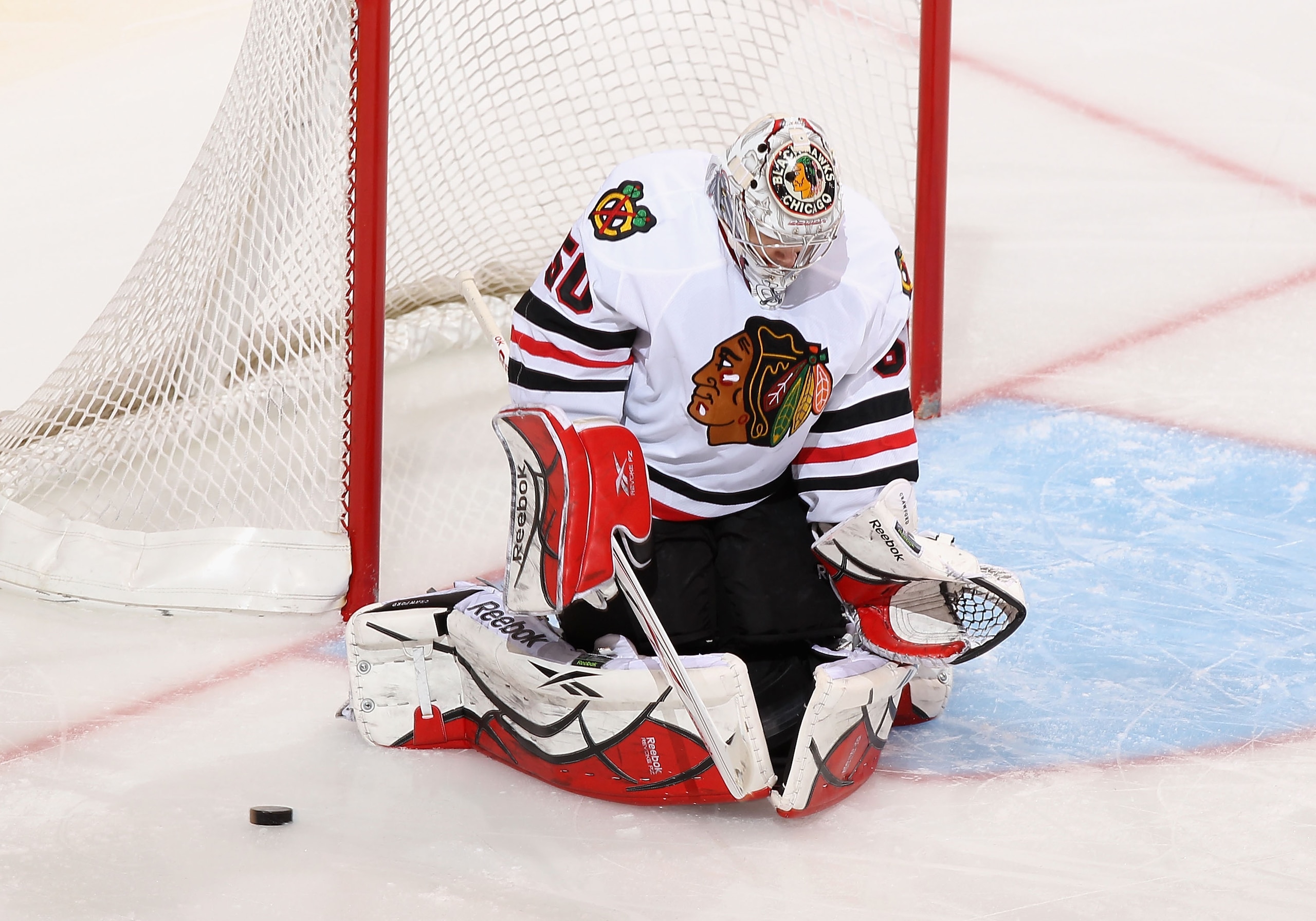 GLENDALE, AZ - MARCH 20:  Goaltender Corey Crawford #50 of the Chicago Blackhawks makes a pad save on a shot from the Phoenix Coyotes during the second period of the NHL game at Jobing.com Arena on March 20, 2011 in Glendale, Arizona.  (Photo by Christian